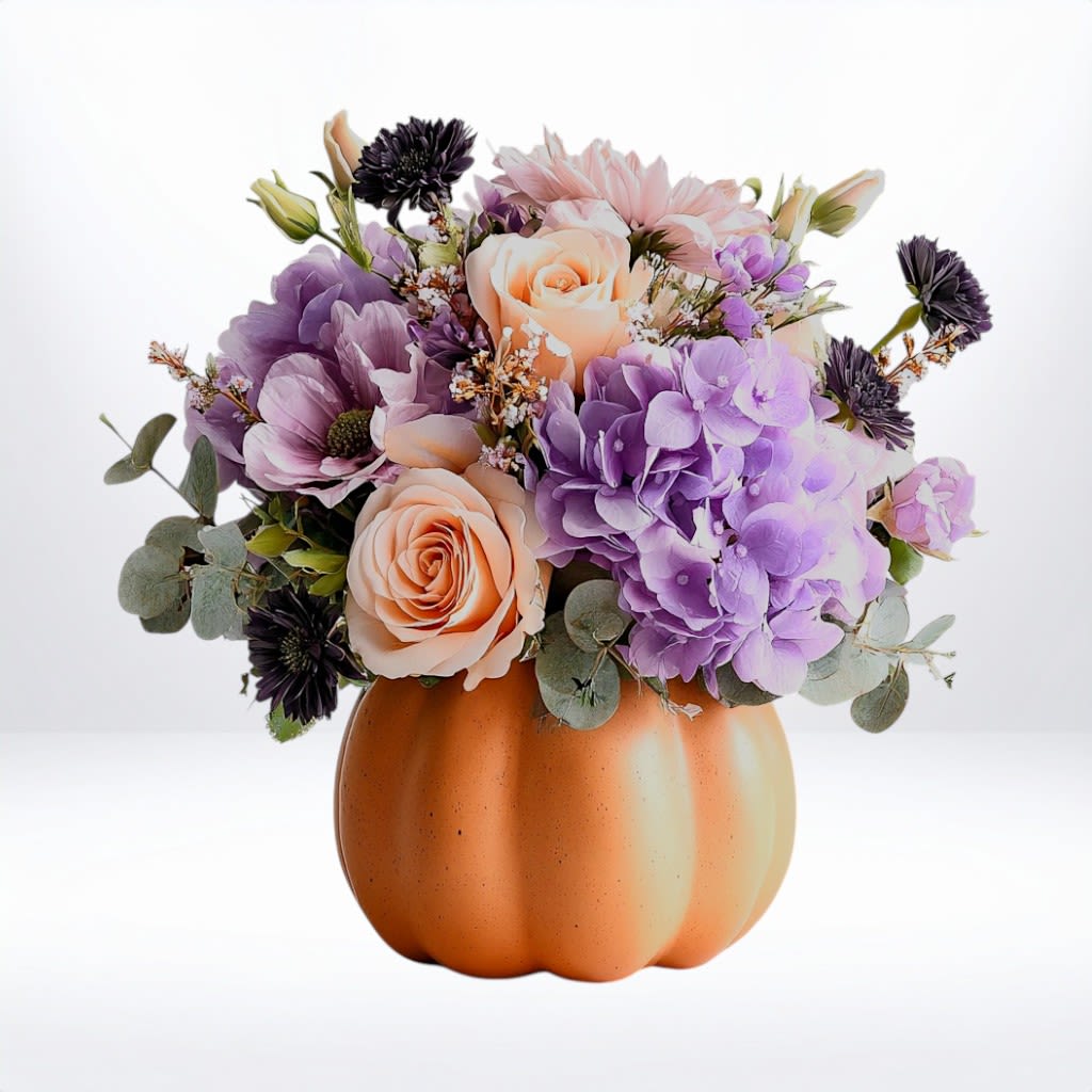 Pumpkin Lavender Daydream - Pumpkin Lavender Daydream This charming pastel arrangement blends soft peach roses, lavender hydrangea, and mauve blooms in a keepsake pumpkin ceramic vase. A whimsical twist on fall colors, perfect for autumn birthdays, thank-you gifts, or desk cheer. Substitution Disclaimer: Due to seasonal availability, some blooms may be replaced with similar varieties of equal or greater value to maintain the design’s look and integrity. Your arrangement will always reflect the same spirit, palette, and premium quality. 
