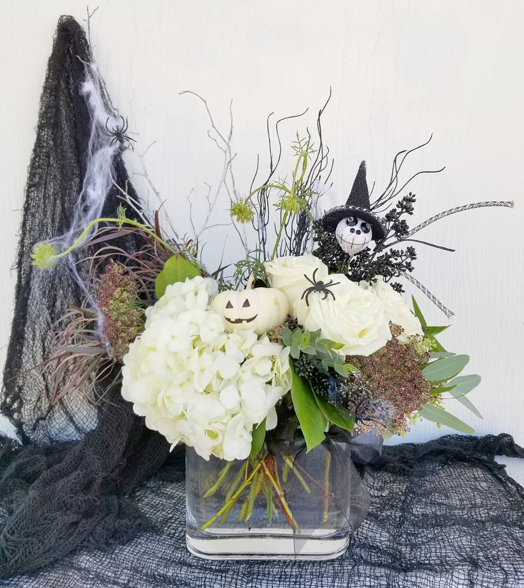 Happy Halloween Happy Halloween - Meet the cute Halloween duo! They are ready to say happy halloween to your nearest and dearest. Vase container, Pumpkin colors and florals may vary depending on availability Shown is a standard arrangement, deluxe adds more flowers to the same vase for a fuller look. Premium is a bigger vase and more flowers.