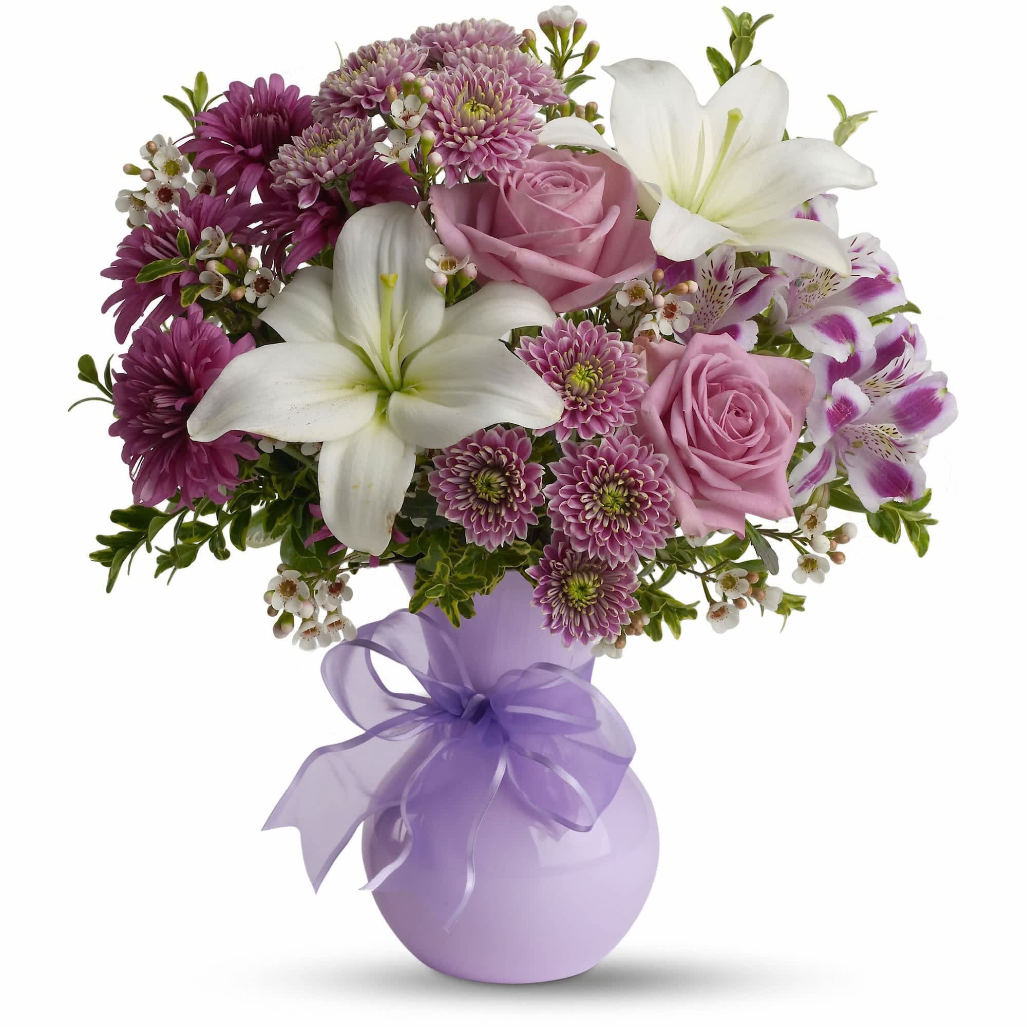 Teleflora's Precious in Purple - If you want to impress someone, send elegant flowers in a soft lavender vase accented with a lavender ribbon. Warm, rich, dramatic, it's the kind of gift that says, &quot;You're special. And so am I.&quot;  