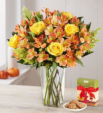 Abundant Autumn Alstromeria Abundant Autumn Alstromeria - Autumn colored alstromeria (orange, yellow, red) arrangement with a few roses and yellow aster filler expertly arranged in a tall clear glass vase. Long lasting with a slight fragrance.