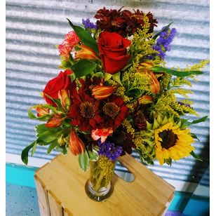 Colors of Fall Colors of Fall - Even with the days getting cooler the colors of the bouquet with warm anyone's day. A designers choice of Seasonal flowers.