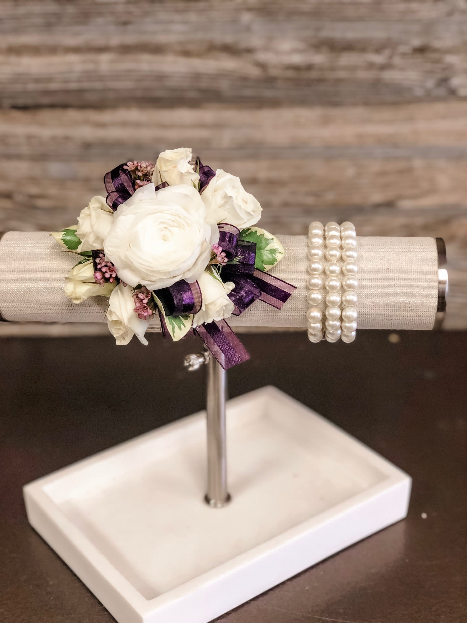 White Spray Rose &amp; Ranunculus Corsage-Select ribbon Color to compliment dress  - White spray roses, White ranunculus, accented with greenery, ribbon made on a faux pearl beaded wristlet.  PLEASE Let us know a ribbon color or Standard ribbon, if not specified, would be a sheer ribbon.  Other wristlets available: silver, gold or black faux pearl as well as Rhinestone.   Ribbon color can match, or compliment, any dress color. Please specify wristlet color and ribbon color with order.   Spray Rose color options:  white, light pink, hot pink, red, yellow, orange &amp; peach if in stock.  PLEASE specify wristlet, ribbon and rose color with order 