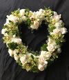 Peaceful Tribute Open Heart Peaceful Tribute Open Heart - Elegant white floral open heart accented by green orchids expresses sympathy and serenity. This sympathy heart includes flowers such as fragrant stock, roses and hydrangeas, green cymbidium orchids as well as seasonal greens.