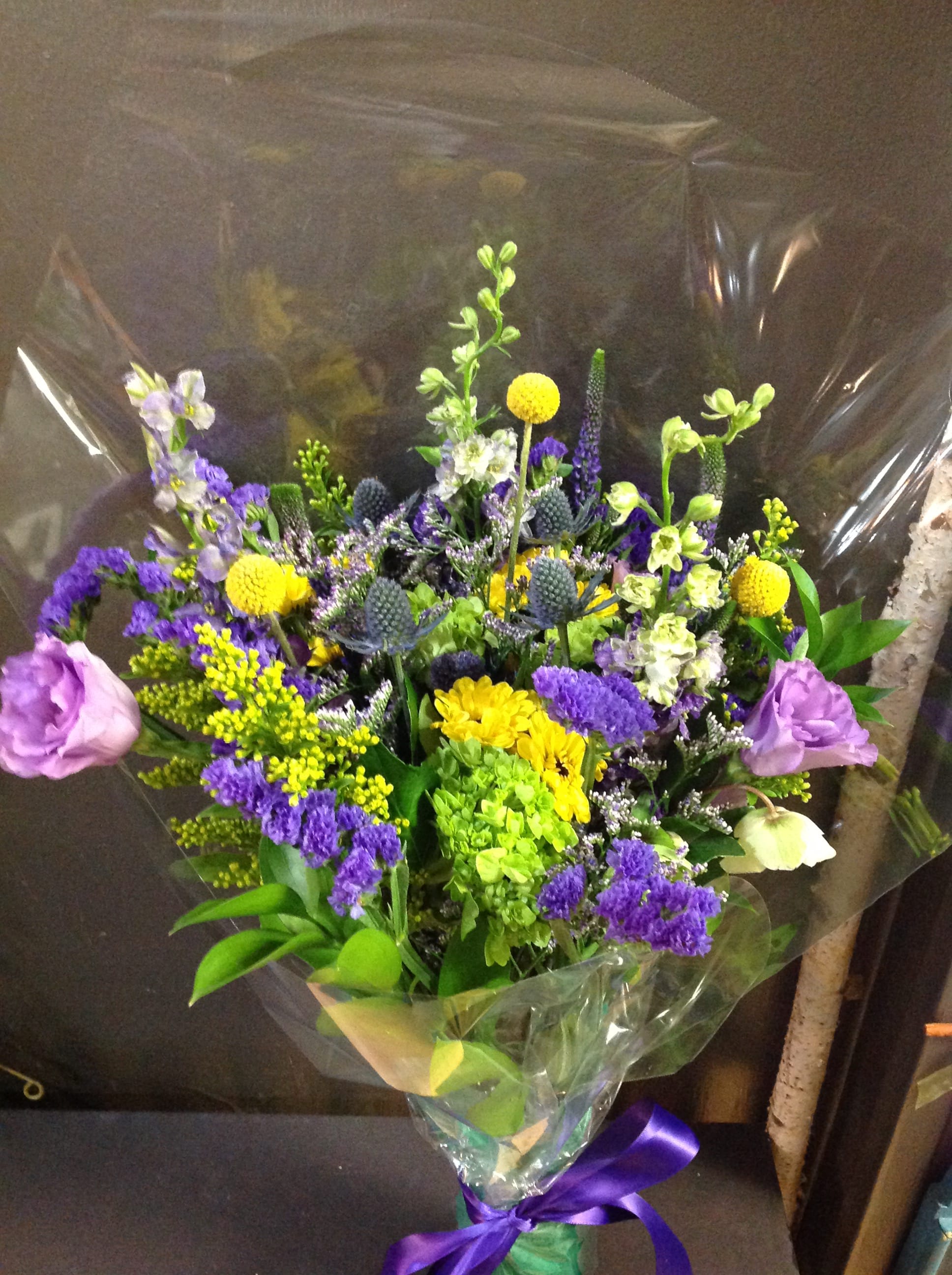 Pops of Purple Wildflower Loose Bouquet Pops of Purple Wildflower Loose Bouquet - Beautiful wildflower boquets filled with purples, yellows and greens. Exact flowers included may be substituted due to market availability but color and feel will stay the same. (Does not include a vase)