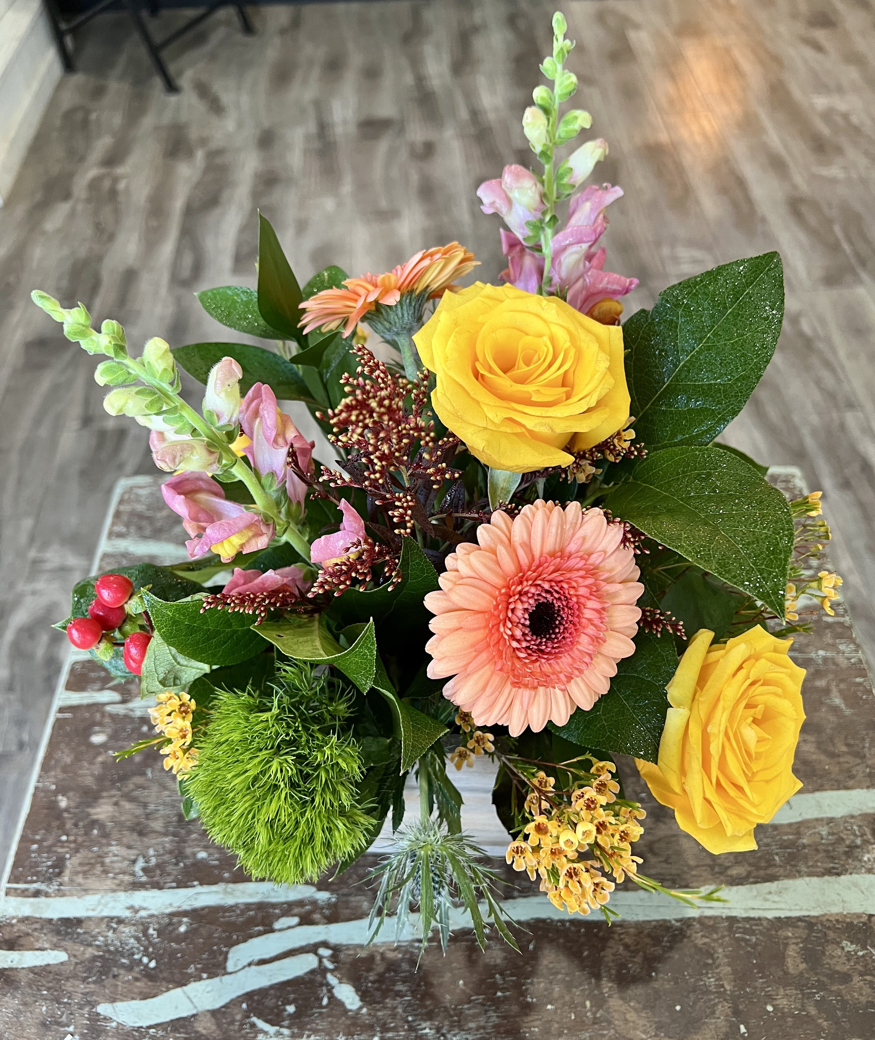 Rustic Harmony - This arrangement features textured greenery, rich autumnal blooms and soft pastels that create a gentle contrast. 