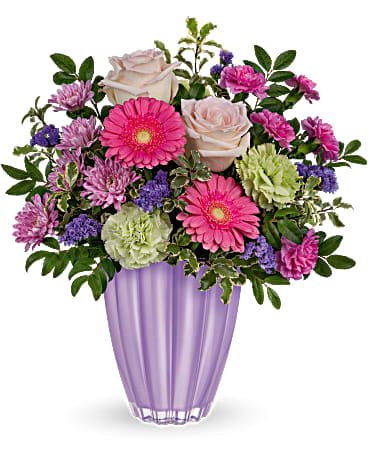 Teleflora's Playful Pastel Bouquet Teleflora's Playful Pastel Bouquet - Crafted of European glass with a shimmering pastel purple finish, this captivating vase perfectly presents a playful bouquet of roses and gerberas. Blush roses, miniature pink gerberas, green carnations, miniature hot pink carnations and lavender cushion spray chrysanthemums are arranged with huckleberry and pitta negra. Delivered in a Playful Pastel vase.