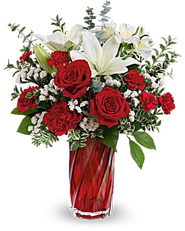 Teleflora's Swirling Love Bouquet Teleflora's Swirling Love Bouquet - Swirling art glass and romantic red roses come together in high style for an unforgettable Valentine's Day surprise. Red roses, white asiatic lilies, white alstroemeria, red carnations, miniature red carnations and white sinuata statice are arranged with spiral eucalyptus, oregonia and lemon leaf. Delivered in a Swirling Splendor Vase.