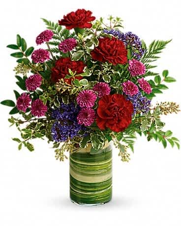 Teleflora's Vivid Love Bouquet Teleflora's Vivid Love Bouquet - Rich and radiant, this vivid mix of jewel-toned blooms is wrapped with leaves for modern style, but its message of love is timeless. Maroon carnations, purple button spray chrysanthemums, and lavender seafoam statice are accented with seeded eucalyptus, leatherleaf fern, pitta negra, huckleberry, and variegated aspidistra leaf. Delivered in a Clear Glass Cylinder Vase.