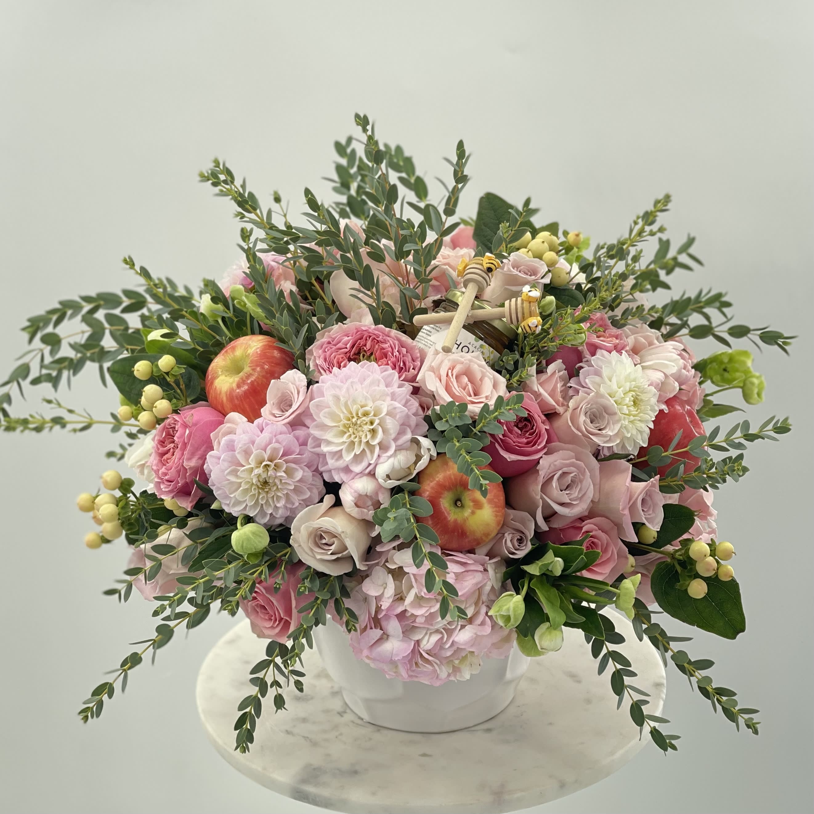 Rosh Hashanah small vase - Beautiful arrangement of fresh flowers in a white ceramic vase with the apples and honey on top for your perfect new year celebration 