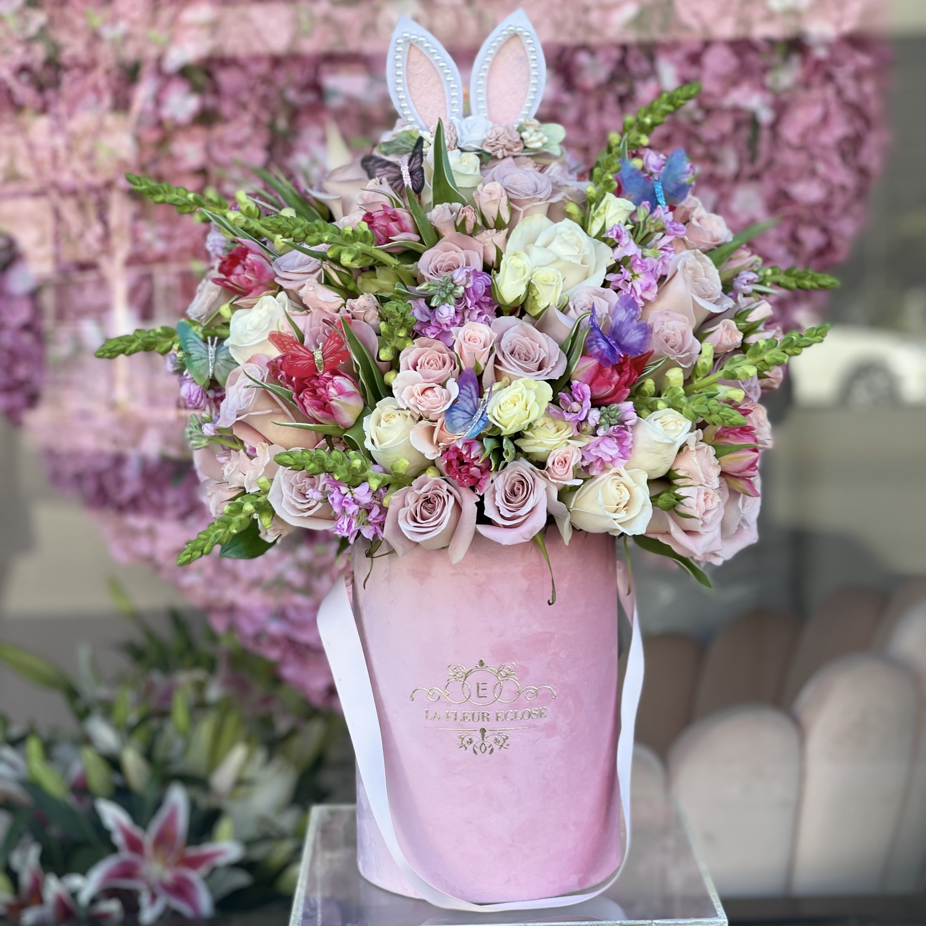 Bunny and Butterflies  - Bunny and butterflies in a pink velvet box with fresh flowers  Bunny ears can vary