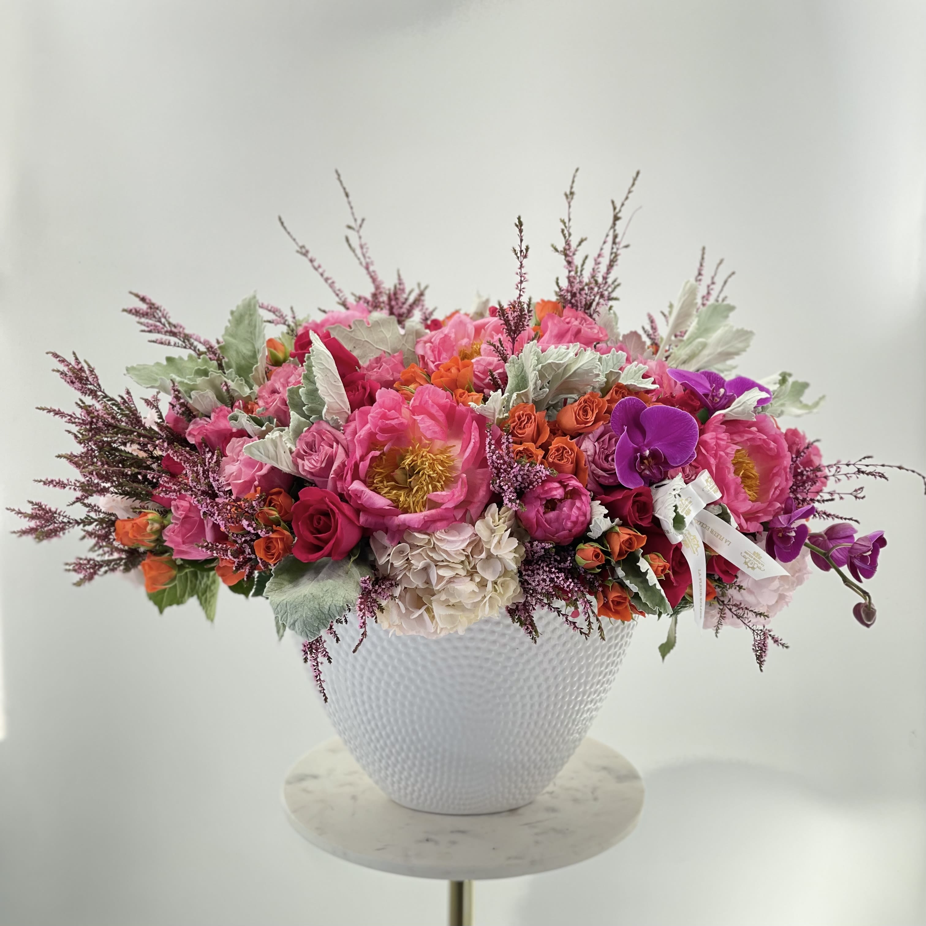 Cheerful day - Beautiful arrangement of pink flowers in a white ceramic vase 