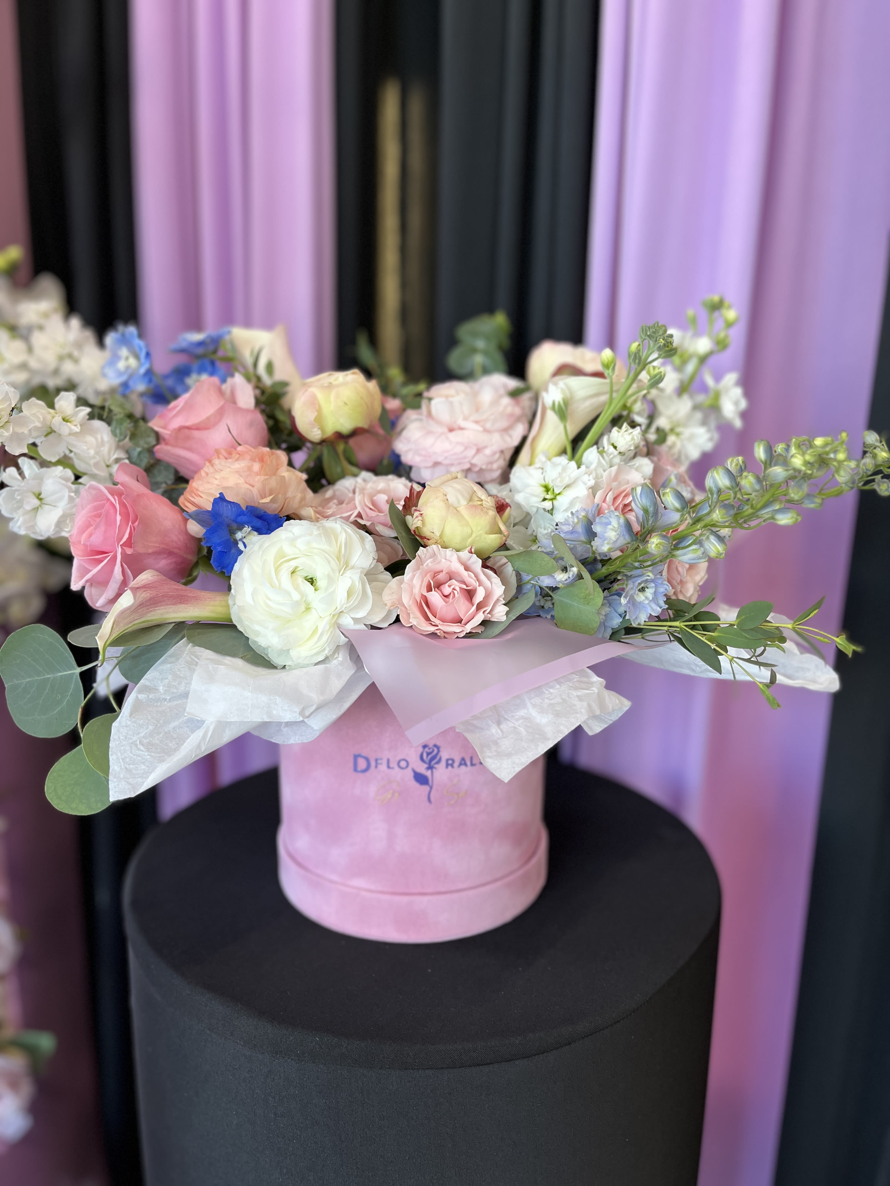 Beauty of the Moment“ bouquet in the box Beauty of the Moment“ bouquet in the box - In some instances, our photo may represent an overall theme or look and include a one-of-a-kind vase which cannot be exactly replicated. Although the actual bouquet may not precisely match the photo, its temperament will. Occasionally, substitutions of flowers and/or containers happen due to weather, seasonality and market conditions which may affect availability. If this is the case with the gift you’ve selected, we will ensure that the style, theme and color scheme of your arrangement is preserved and will only substitute items of equal value or higher value. If any design elements are of major importance to your order, please include them in the florist instructions at checkout or contact us to ensure availability.