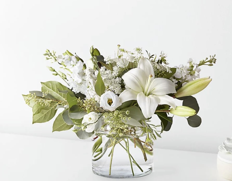 Alluring Elegance Bouquet - An illuminating array of florals brings an air of elegance to any room it's placed. This arrangement features refined florals like lilies, Queen Anne's Lace and Veronica in a clear glass vase to add a touch of sophisticated style to your special occasions.