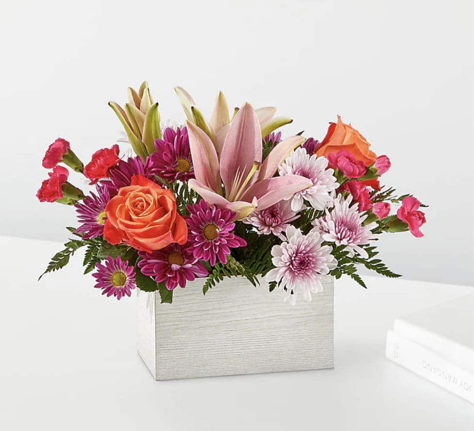 Light of My Life Box Bouquet - From life's big moments to sweet just because sentiments, the Light of My Life Box Bouquet is designed to celebrate your loved ones any day of the year. RSVP'd to the party are hot pink carnations, orange roses, lavender cushion poms and lush greens.