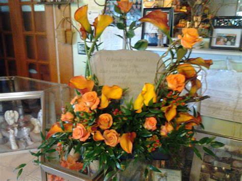 Custom Specialty Stone Design Custom Specialty Stone Design - Let our creative designers encase your specialty stone with calla lillies, roses and other flowers to make just the right style for your loved one. Specialty Stones and Floral Colors can be chosen while consulting with designer.