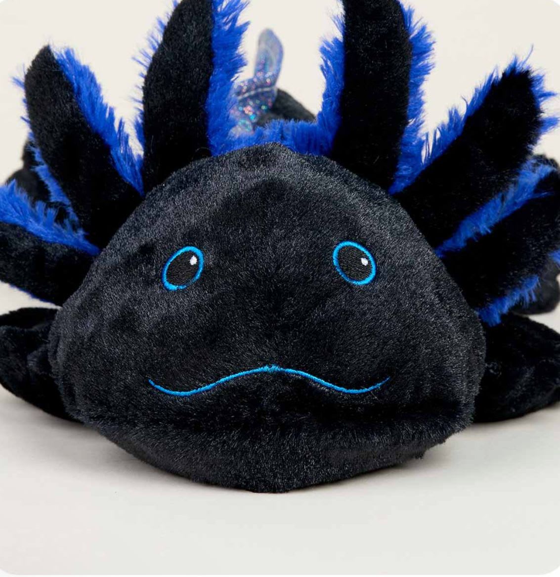 Black Axo Warmie Junior  - Warmies® Juniors Plush are fully microwavable to provide soothing warmth and comfort. These adorable soft toys are scented with real dried French lavender and perfectly weighted for a positive sensory experience. Warmies make an ideal gift for all ages. Quick Facts: Simply Warm in a Microwave Soothes, Warms and Comforts Scented with Real French Lavender Chill in a Freezer for Cooling Relief Safe for all Ages Dimensions: 11.5”x5.5”x3.5” Weight: 0.5lbs