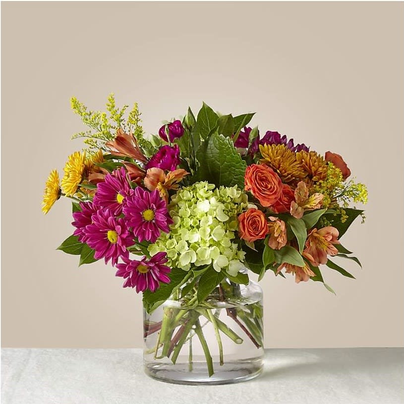 Crisp &amp; Bright Bouquet - If the lively Crisp &amp; Bright bouquet doesn't inspire you to throw a party, nothing will. This eye–catching arrangement will not only wow your guests with its warm palette of vibrant pinks and oranges but could also brighten a friend's day when it arrives on their doorstep.  Please Note: The bouquet pictured reflects our original design for this product. While we always try to follow the color palette, we may replace stems to deliver the freshest bouquet possible, and we may sometimes need to use a different vase.  DETAILS The Deluxe Bouquet is about 14&quot;H x 16&quot;W. The Premium Bouquet is about 18&quot;H x 20&quot;W. The Exquisite Bouquet is about 20&quot;H x 22&quot;W. Designed by our florists, ready to display. For long–lasting blooms, replace the water daily. We suggest trimming the stems every couple days. STEMS Carnation Hydrangea Rose