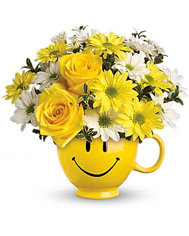Teleflora's Be Happy® Bouquet with Roses Teleflora's Be Happy® Bouquet with Roses - There are probably a million reasons this is such a popular bouquet. Of course, there are probably just as many reasons to send this cheerful arrangement. Full of happy flowers, this ceramic happy face mug will bring smiles for years to come. Especially when filled with that first cup of morning coffee or cocoa! Yellow roses and daisy spray chrysanthemums along with white daisy spray chrysanthemums and oregonia are delivered in the one and only Be Happy® mug.