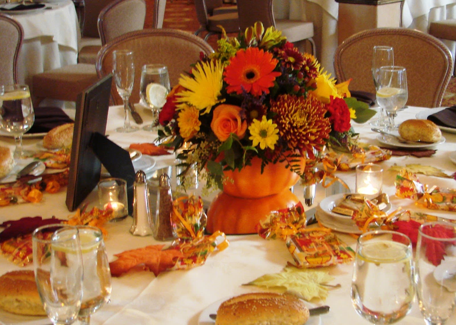 Pumpkin floral arrangement - MIxed florals in an artificial pumpkin, with fall flowers such as mums, sunflowers, daisies, etc...bright and pretty