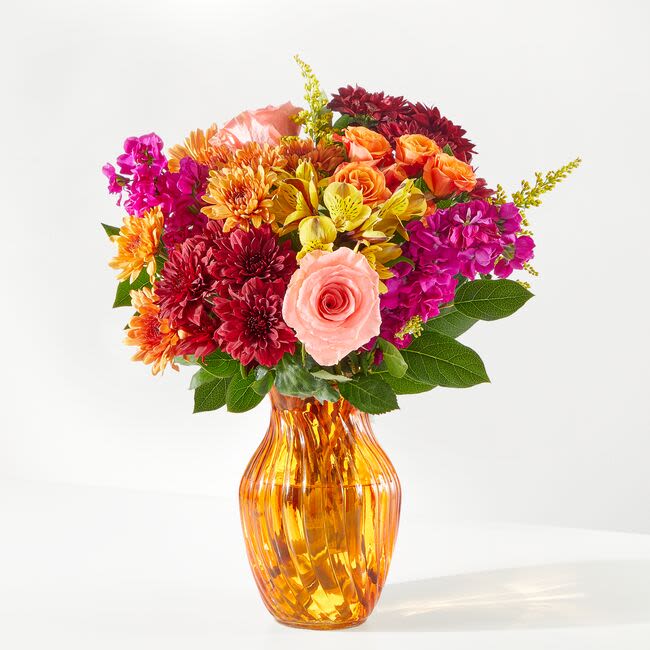 Amber Muse Bouquet - This rich palette of jewel tones meets fall splendor and come together in this gorgeous orange vase to create the perfect smile  
