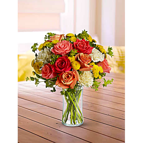 Citrus Kissed - Like freshly squeezed lemonade on a hot sunny day this bright and cheerful bouquet is a summer sensation. Dark orange coral and orange roses light yellow carnations yellow button spray chrysanthemums and greens fill a slender gathering vase. It's a kiss of summer!Approximately 11&quot; W x 14&quot; H Orientation: All-Around As Shown : T157-1ADeluxe : T157-1BPremium : T157-1C