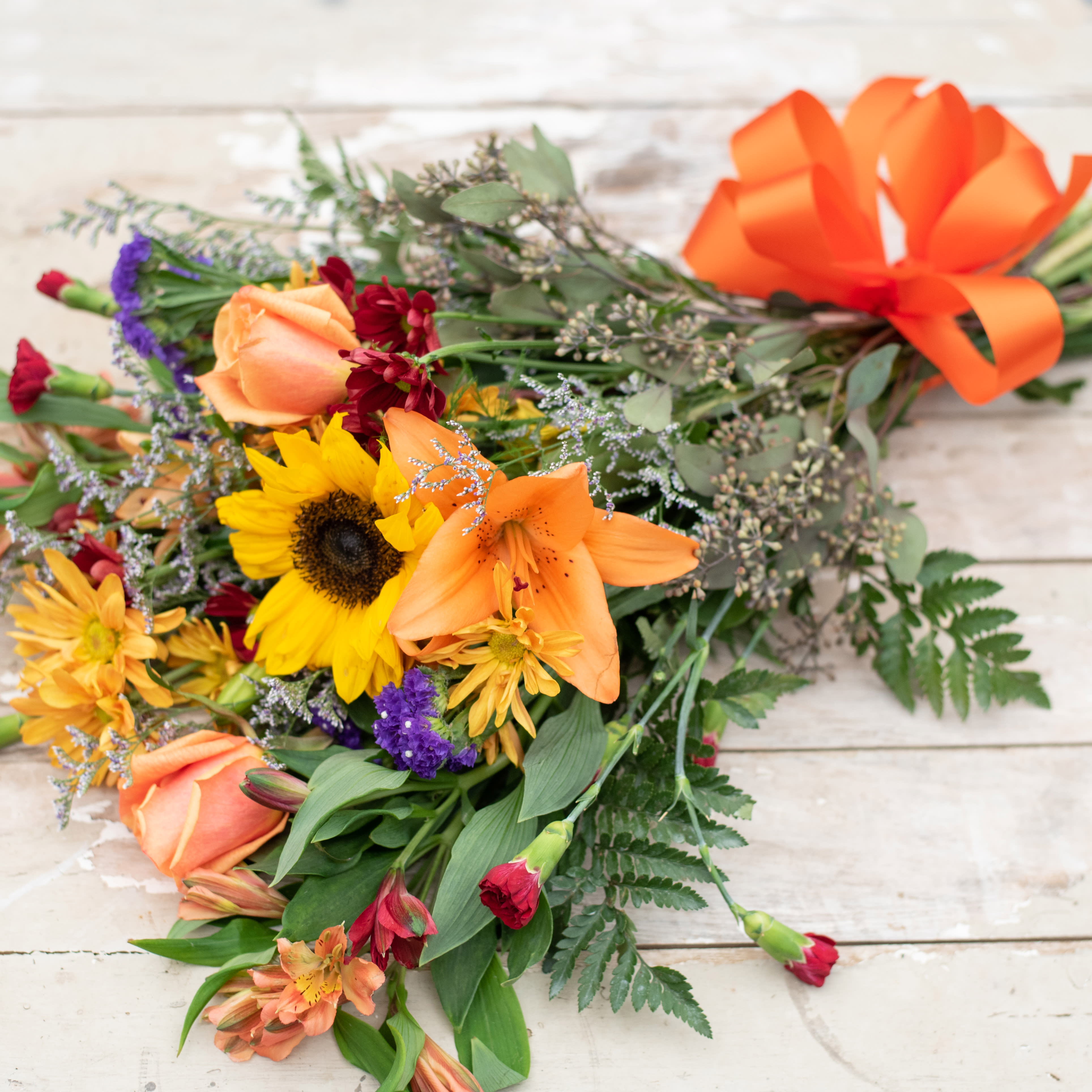 Fall Cut Flower Bouquet - Let our designers choose a variety of seasonal jewel tone blossoms to be wrapped in cellophane and a coordinating bow to place in your own vase at home.  