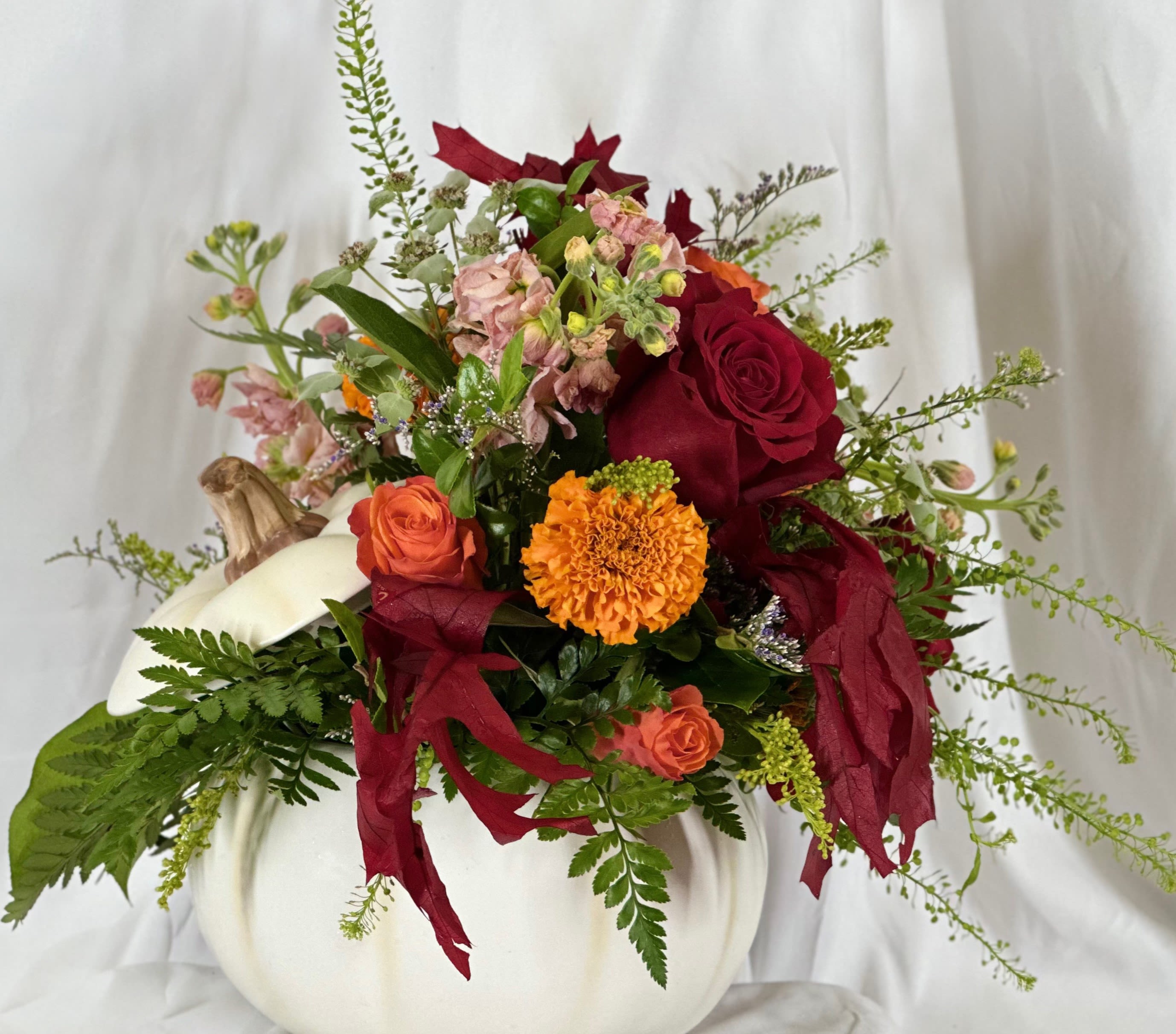 White Pumpkin Magic - Fun and festive, this Fall flower arrangement features Autumn hues of stock, roses, and other seasonal flowers