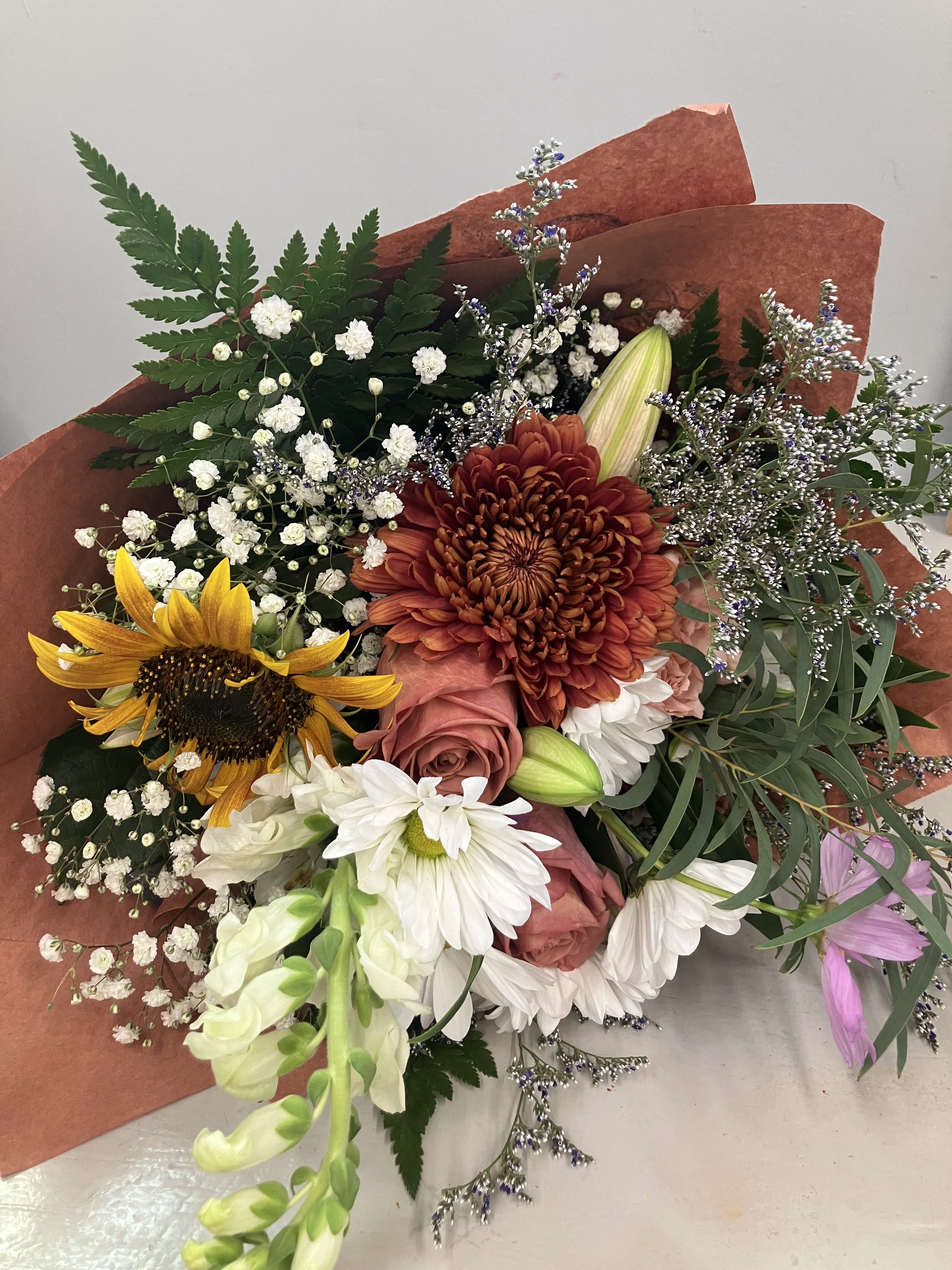 Wrapped Flowers - The ever classic wrapped bouquet, we will send a mix of flowers wrapped in beautiful paper to your loved one who can then arrange them in a vase. *Colors and flowers will vary  Please note: Any order that requires timed or rush delivery will require an additional fee of 15:00 that you will need to add to your order at check out. 