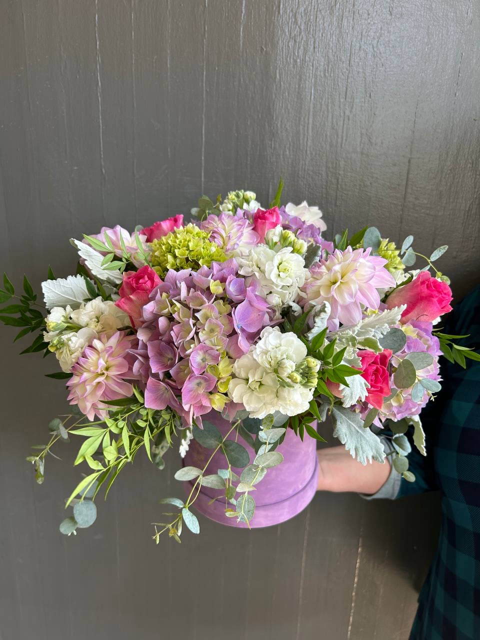 Essence of Summer  - This design includes dahlias, roses, and hydrangeas arranged with eucalyptus and stock to accentuate the velvet purple box it is designed in.