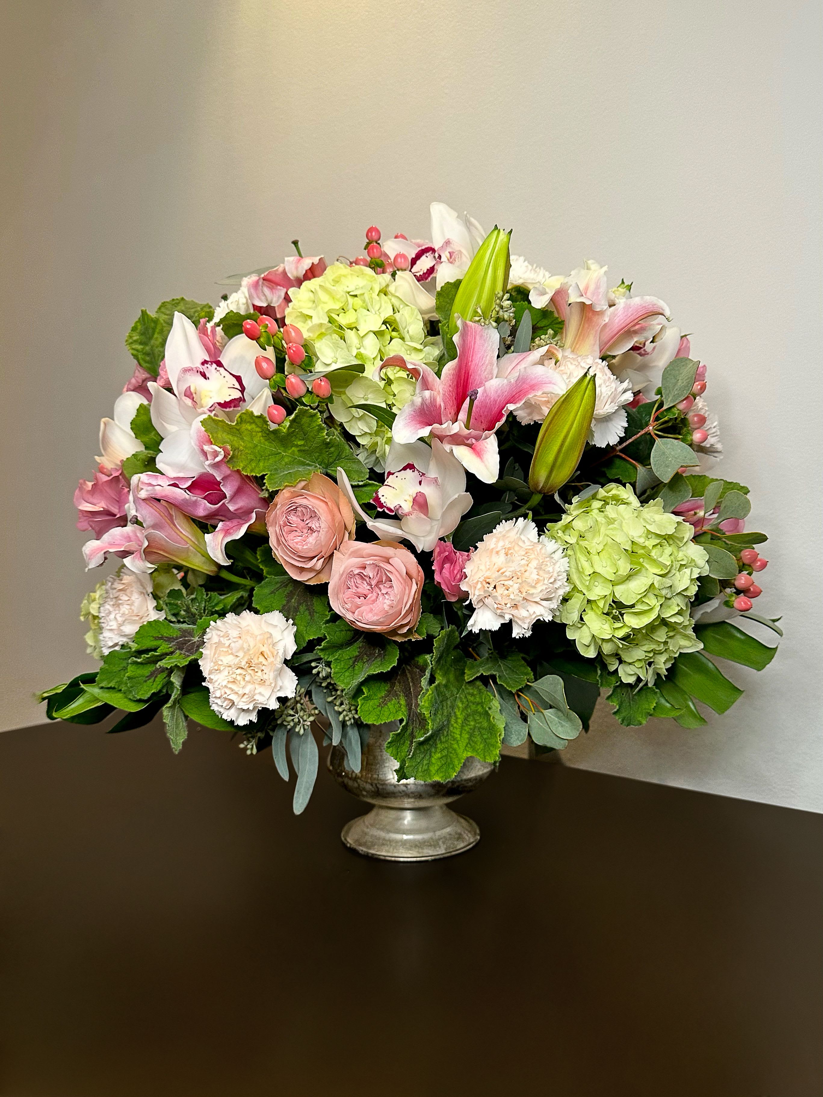 Lily Rose - An elegant mix of premium roses, lilies, and hydrangea with soft greenery. A timeless bouquet of beauty and charm.  Type of Flower: Lilies, Roses, Hydrangea, Dianthus, Hypericum, Eucalyptus.  The bouquet comes with the vase.