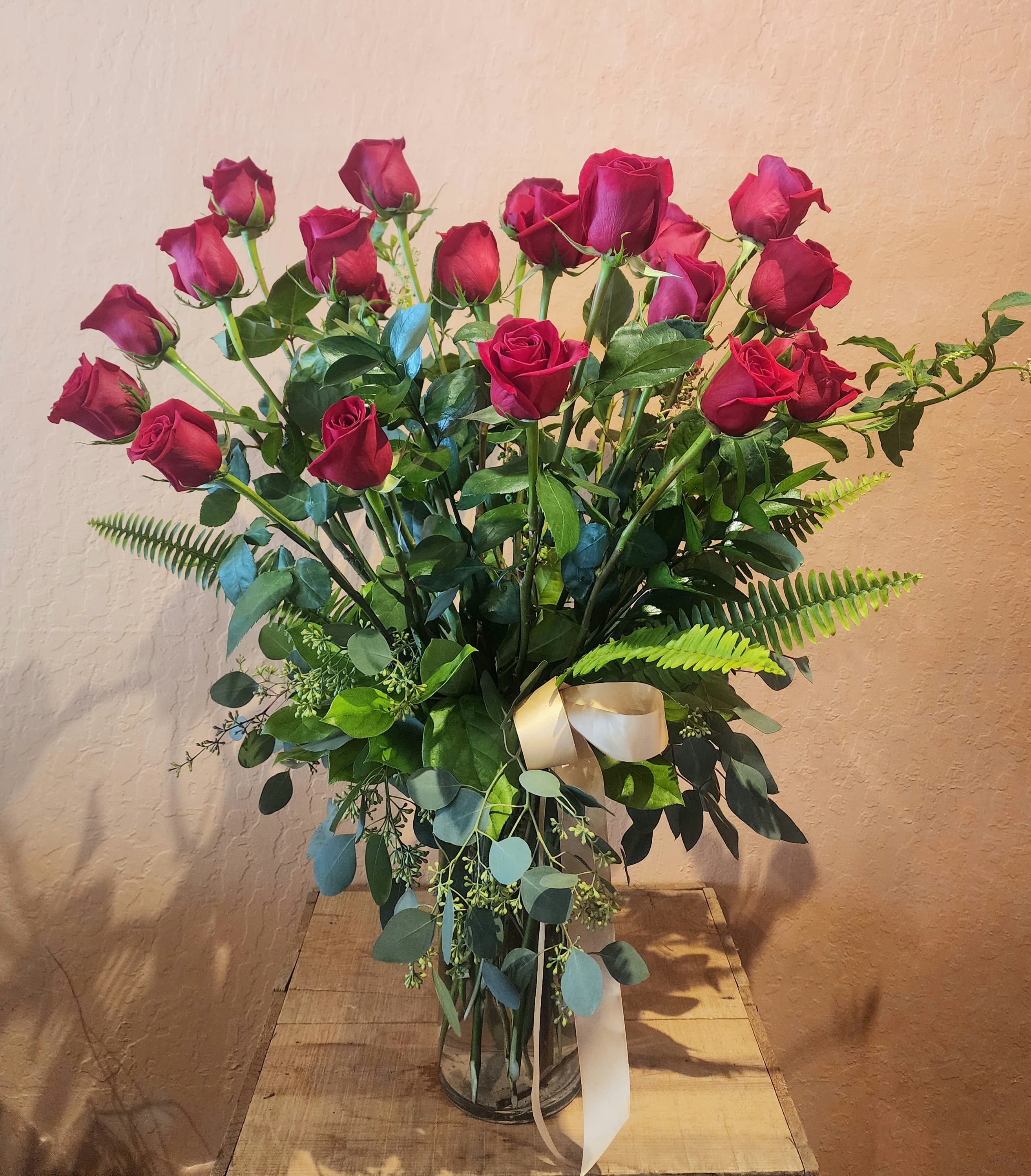 Long Stem Red Roses 24-48 Long Stem Red Roses 24-48 - Classic red roses and interesting greenery. MAY REQUEST babies breath, otherwise will not contain. These are high quality imports. Long stem in a tall slender vase.