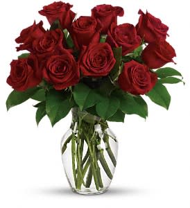 Enduring Passion - Dozen Red Roses Enduring Passion - Dozen Red Roses - A dozen red roses is a timeless gift of love, and the time is always right to give and receive this enchanting gift. Birthday, anniversary or just because, the magic of roses will always cast its spell. You'll see. This romantic bouquet includes one dozen red roses accented with lush greenery. Delivered in a clear glass rose vase. Approximately 14 1/2" W x 15 3/4" H Orientation: All-Around