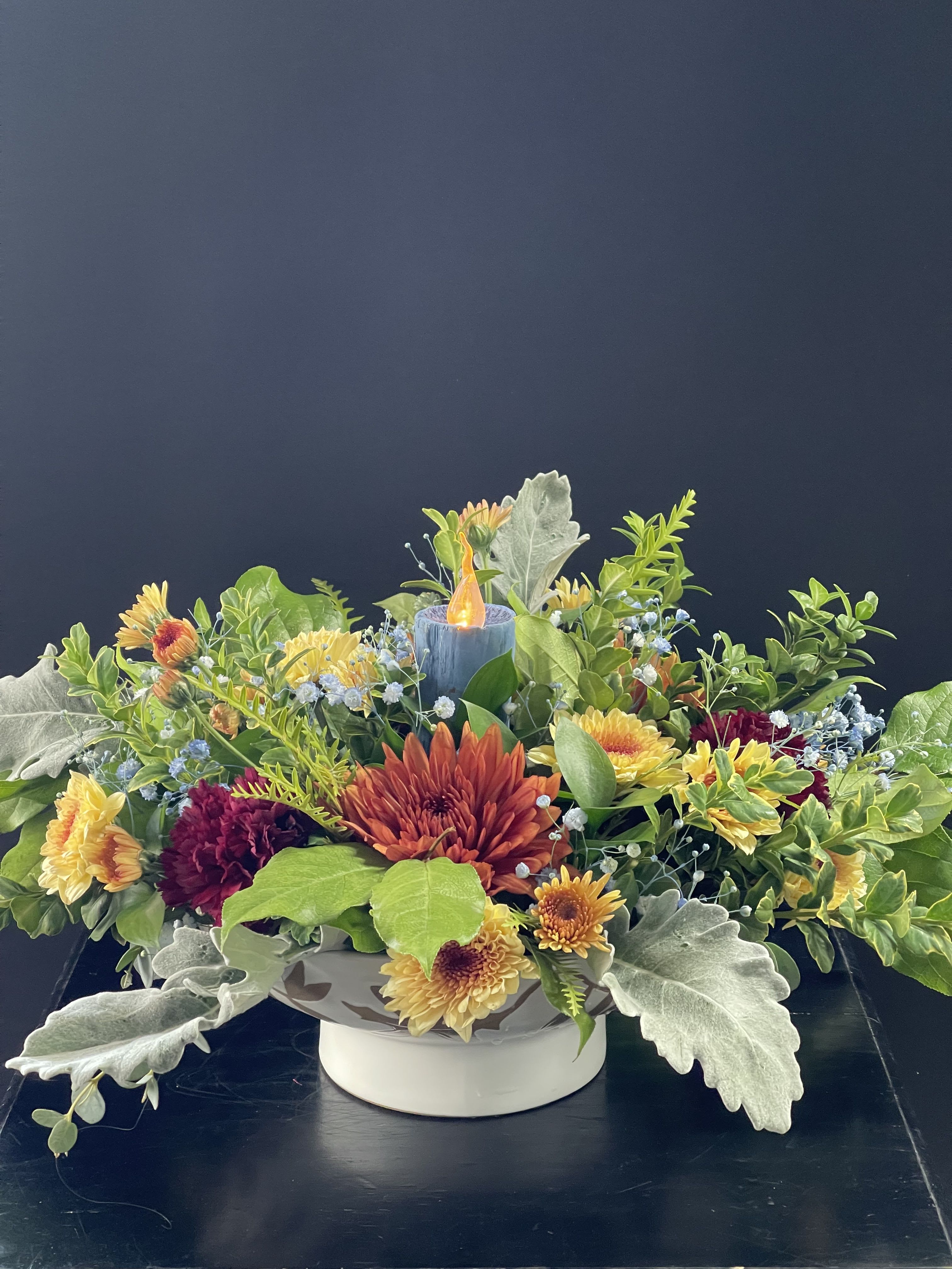 Harvest Table Centerpiece - This floral arrangement comes in a beautiful ceramic bowl with leaves and a blue LED Faux wood candle.  This brings a rustic feel to your table.