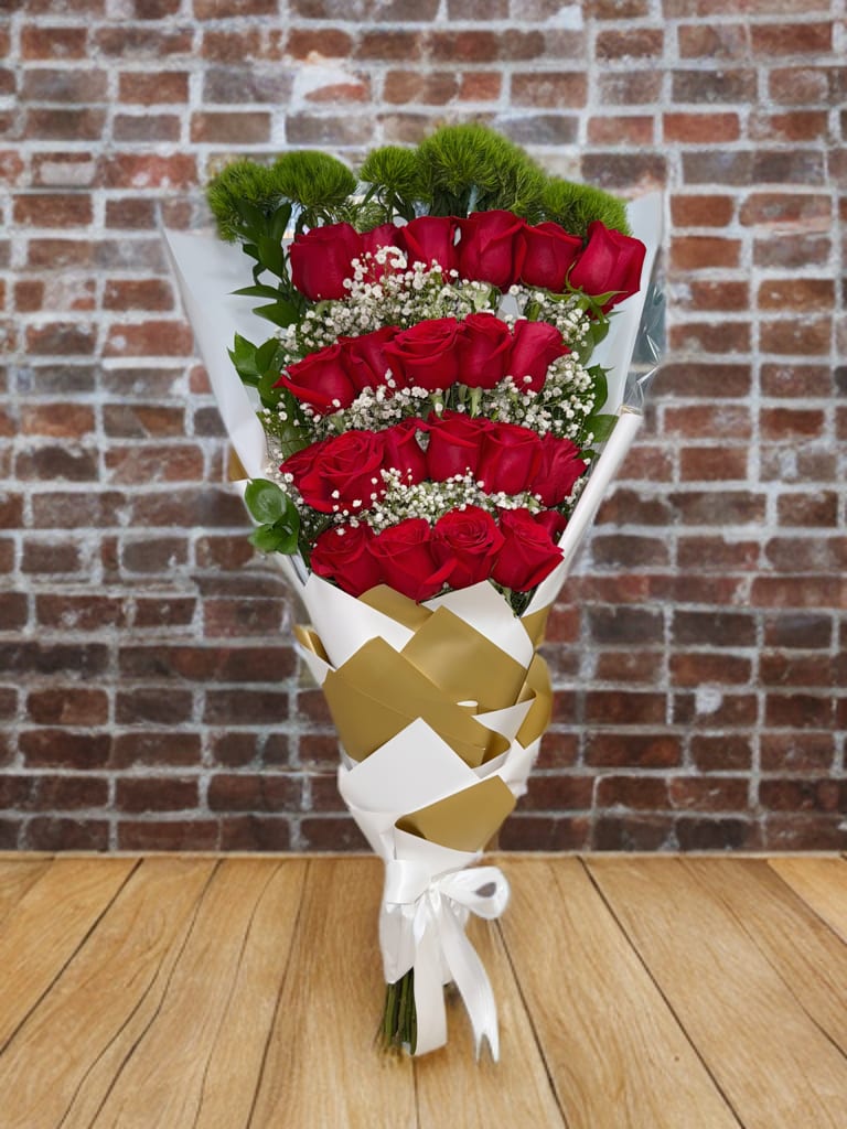 Timeless Love Bouquet Timeless Love Bouquet - It beautifully features rows of elegant red roses accented with baby’s breath, lush greenery, and wrapped in modern gold-and-white paper with a satin ribbon — a perfect symbol of romance, admiration, and sophistication.