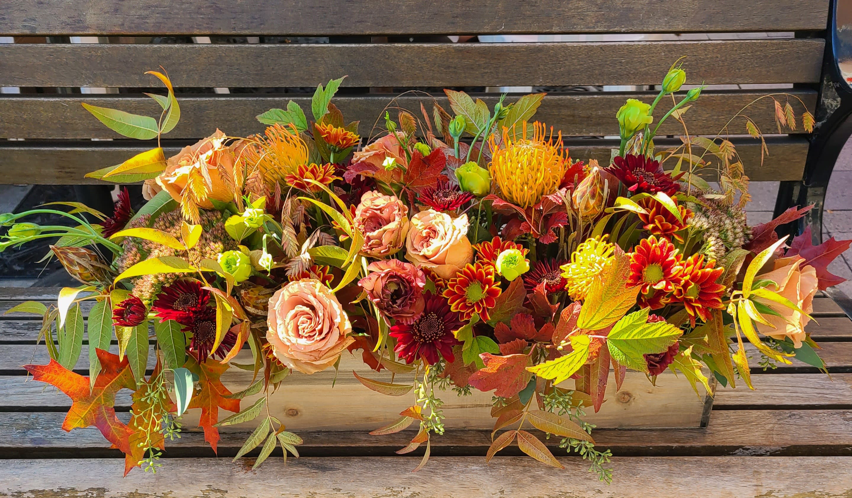 Sweater Weather -  This low centerpiece design is arranged in a 20&quot;x4&quot; wooden box. This autumn color palette is sure to make you feel cozy just like your favorite cold weather sweater.