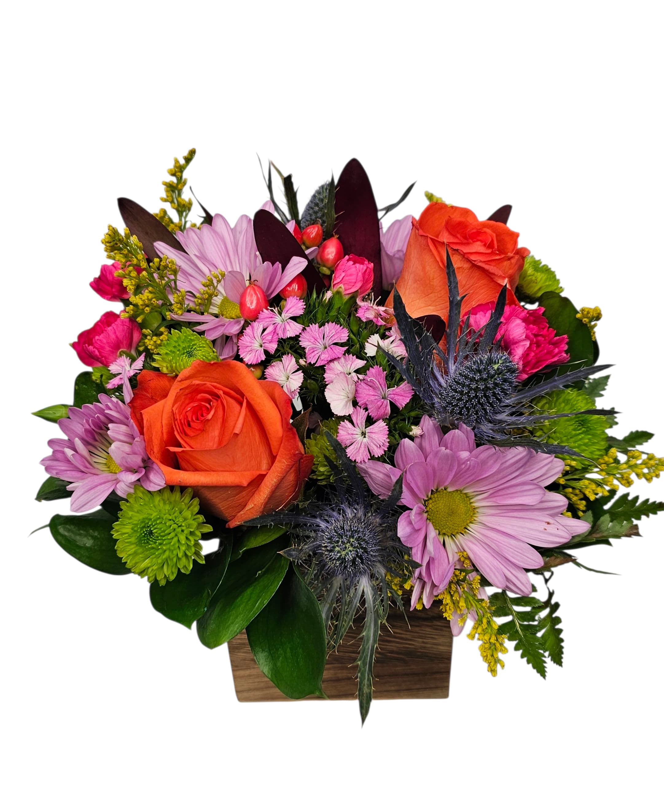 Cottage Carnival - Step into a whimsical celebration of color with our &quot;Cottage Carnival Bouquet,&quot; a vibrant, joyful blend inspired by the spirit of a lively garden party. This enchanting arrangement features radiant orange roses that infuse warmth and energy, paired with cheerful hot pink mini carnations bursting with playful charm. The exotic safari sunset flowers add a captivating touch of sunset hues, while sweet William blossoms bring classic elegance to the mix.  Soft lilac daisies sprinkle delicate charm, beautifully balanced by lush green fillers and foliage that bring the bouquet to life with natural freshness. Together, these blooms create a festive, eye-catching display that’s perfect for brightening any space or occasion.  Whether gifting a loved one or treating yourself, the Cottage Carnival Bouquet promises to fill hearts and rooms with vibrant joy and cottage-inspired delight.  Approximately 10&quot; W x 10&quot; H