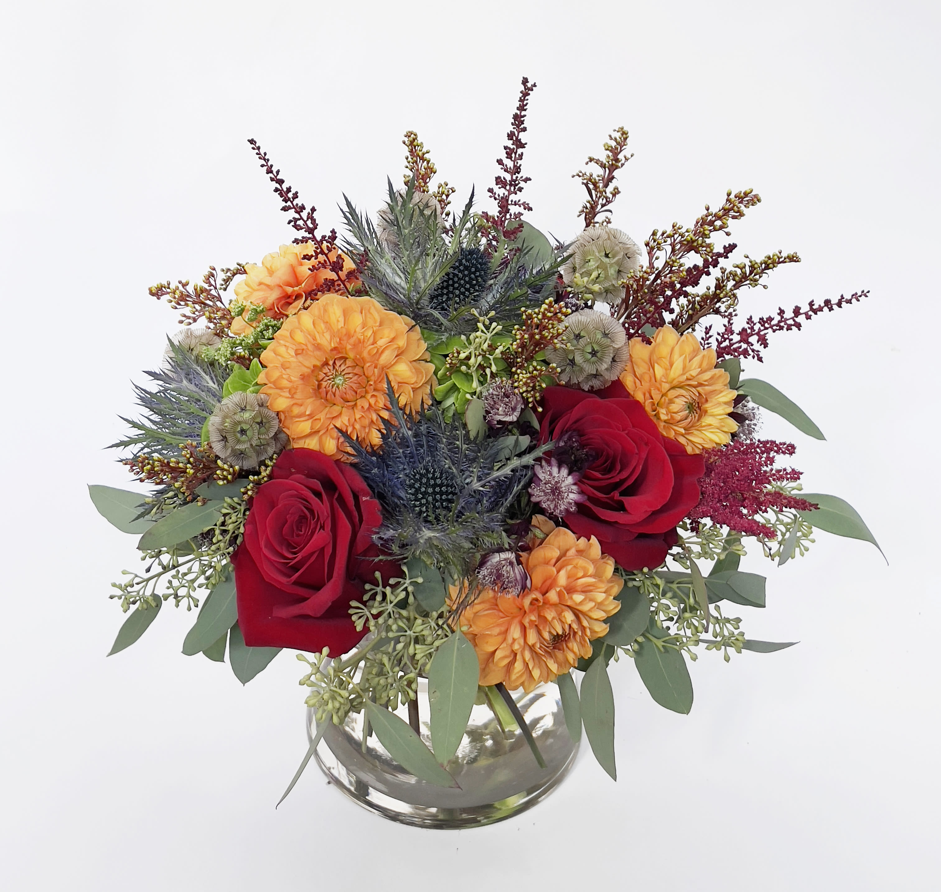 Dahlia and Thistle Dahlia and Thistle - A dark rich color arrangement, features orange dahlias and thistle.