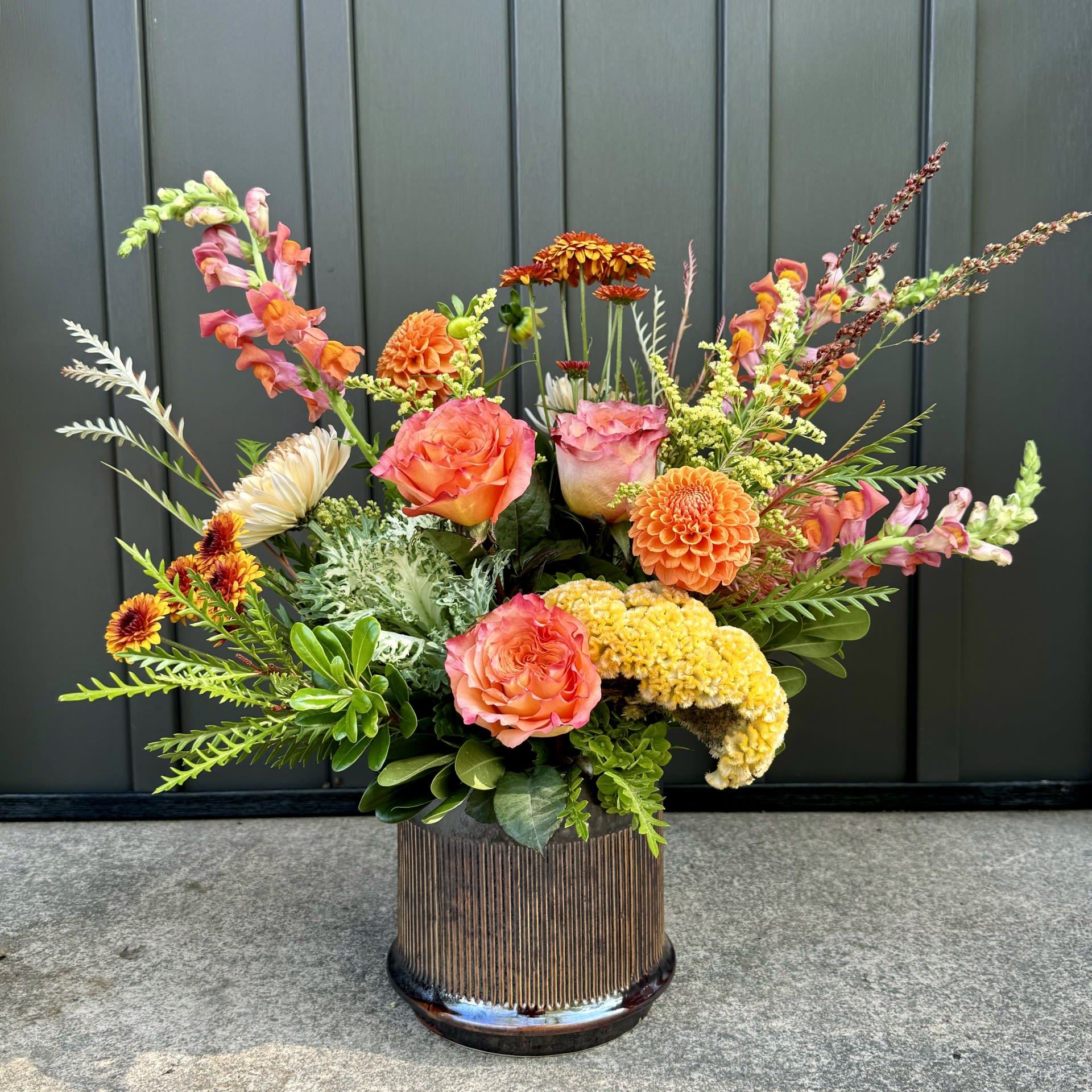 Fall Splendor Fall Splendor - This arrangement celebrates the bounty of fall in rich and bold autumn tones of snapdragons, roses, and mums.