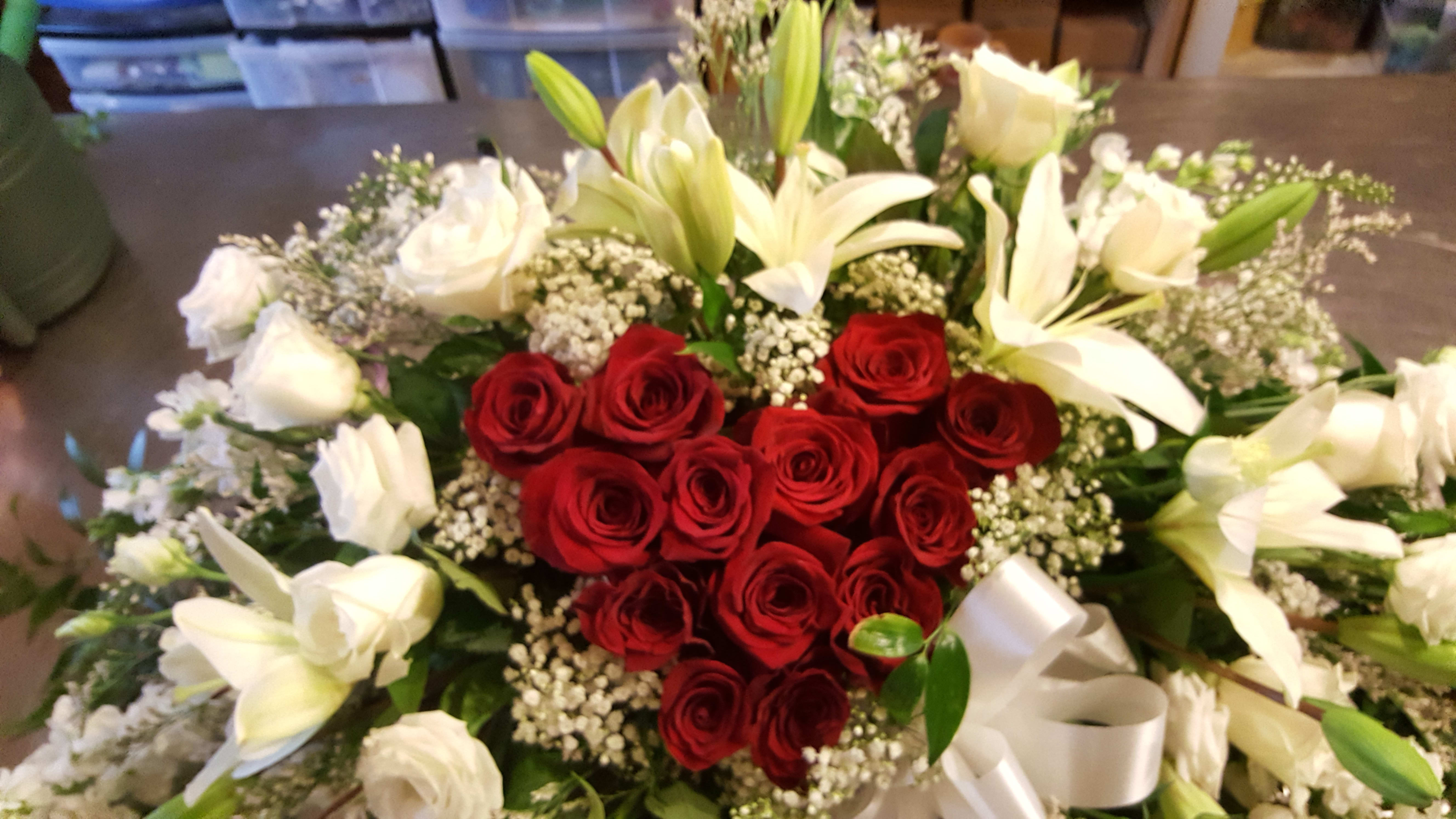 You are my Heart - This design is full with white lillies, roses, babies breath and a red rose heart in the middle to express your love. 