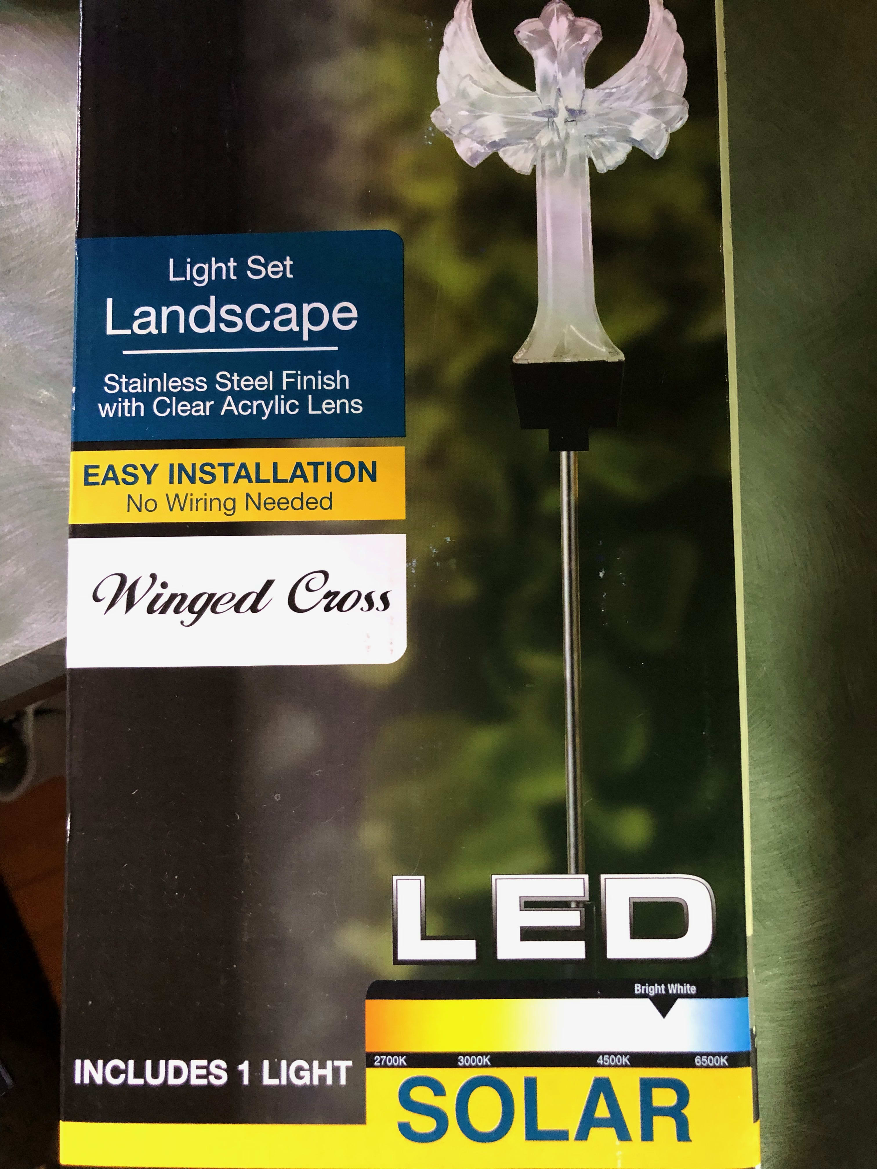 Solar Winged Cross - LED Solar Winged Cross. Stainless steel finish with a clear acrylic lens. Wonderful tribute can be placed graveside or displayed in the yard. Needs full sun to charge the LED lens. 