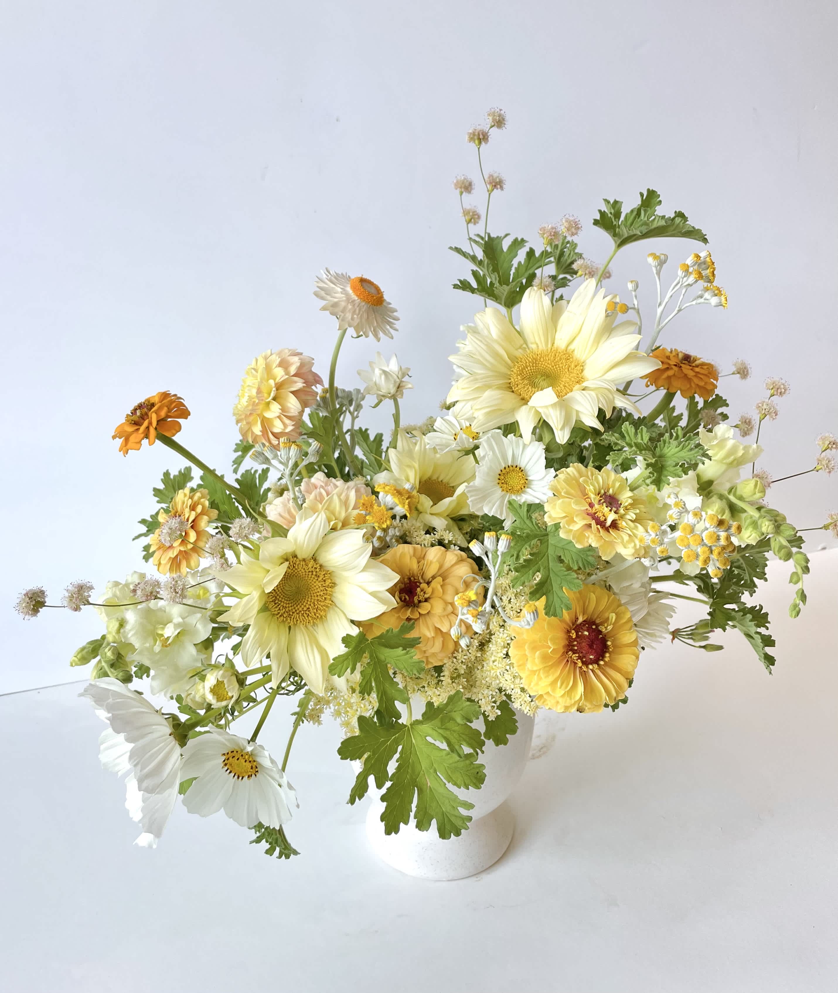 &quot;Buttered Popcorn&quot; Arrangement  - Warm, toasty, buttery blooms! In this arrangement you will see seasonal sunflowers, dahlias, cosmos, zinnias, rudbeckia, and other local goodies.   Concerning Seasonality: As a seasonal, locally-focused florist, we have different product to work with each week. Our focus is on creating a unique piece for each customer, with blooms that are fresh from local farms and growers. While the flower varieties and colors may vary, the quality and freshness will always be the best. It is an honor to have our customers' trust and confidence in our abilities and artistic eye.   Delivery Policy (**PLEASE READ**): Pick-ups at the studio are available after 2pm. Our daily delivery time frame is typically between 12- 3pm. Please specify if you require a certain delivery time and we will do our best to accommodate it, or we will call you if we cannot.   We gently ask that those ordering flowers for someone else to please check first if the recipient of the flowers will be home during that time. Additionally, please be sure to include whether or not there is a gate we may need a code for. If there is no answer at the door, our delivery person will leave the flowers by the doorstep in a weather safe location. Completing your order acknowledges that you have read and understand our delivery policies. 