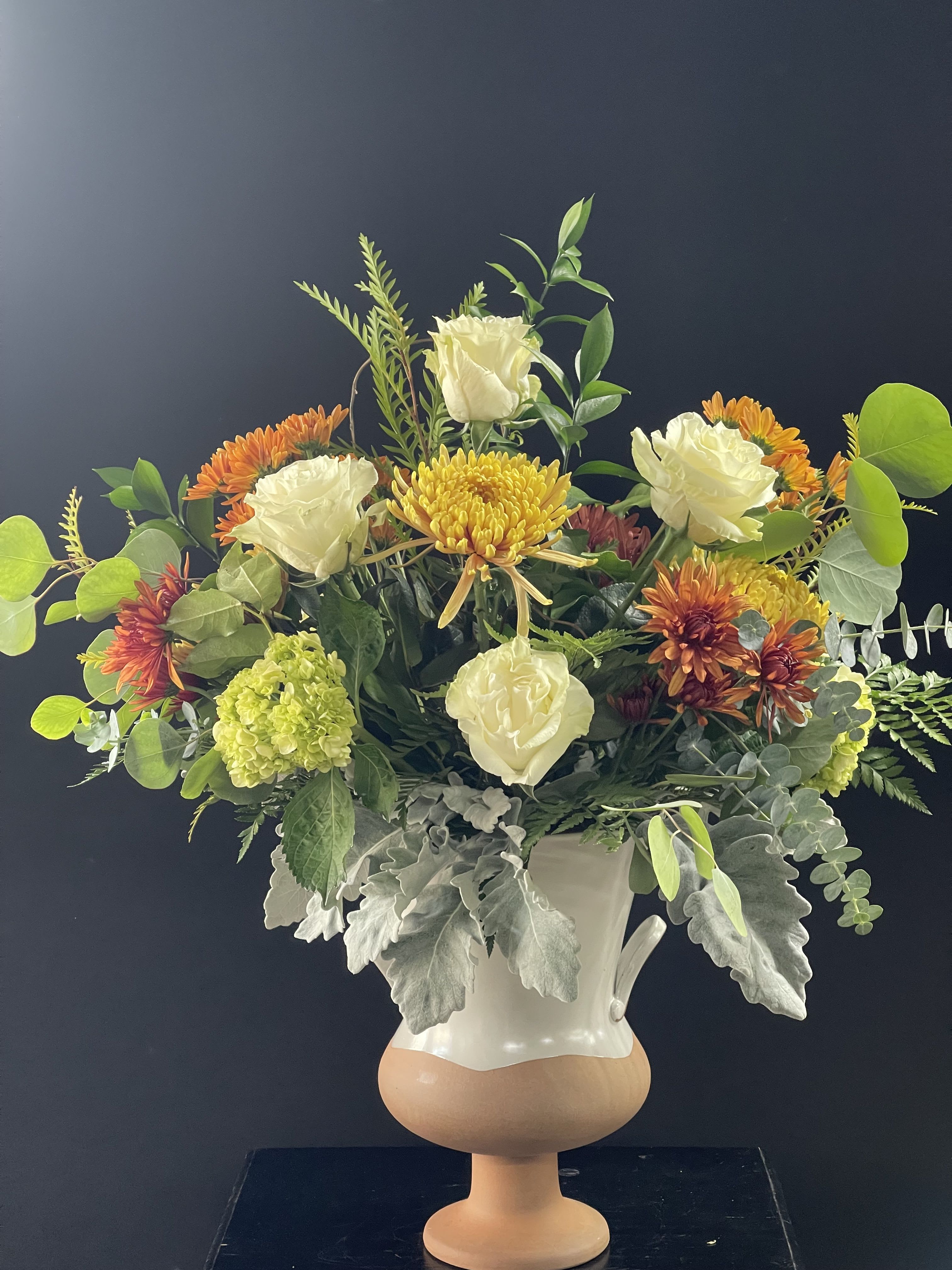 Bountiful Floral Arrangement - Beautiful Eggshell ceramic vase filled with fall blooms and greenery.
