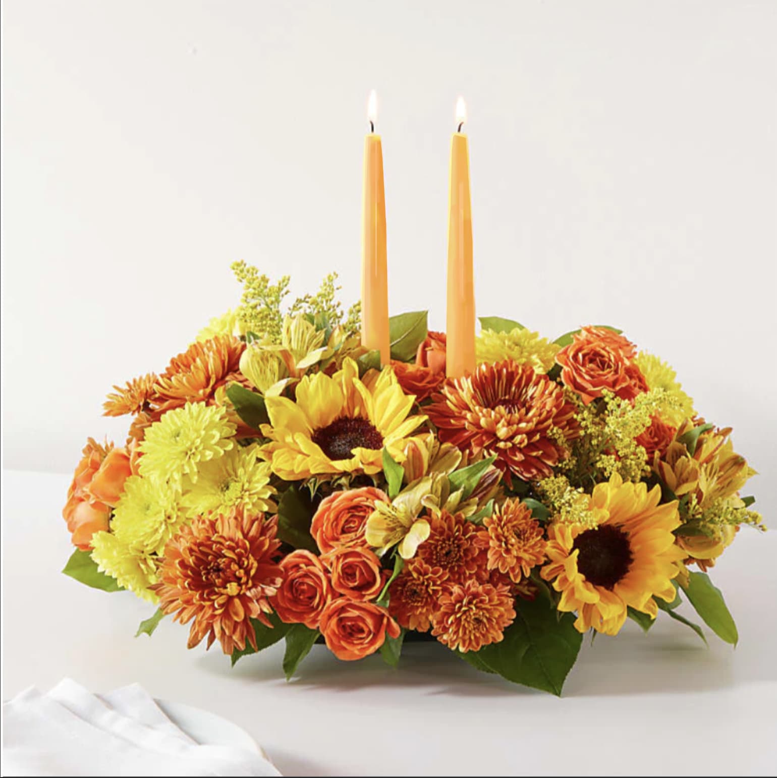 Autumn Joy Centerpiece - Sunflowers mums and more adorn this lovely centerpiece.  Please not.. our yellow candles have sold out.. we have orange candles. 