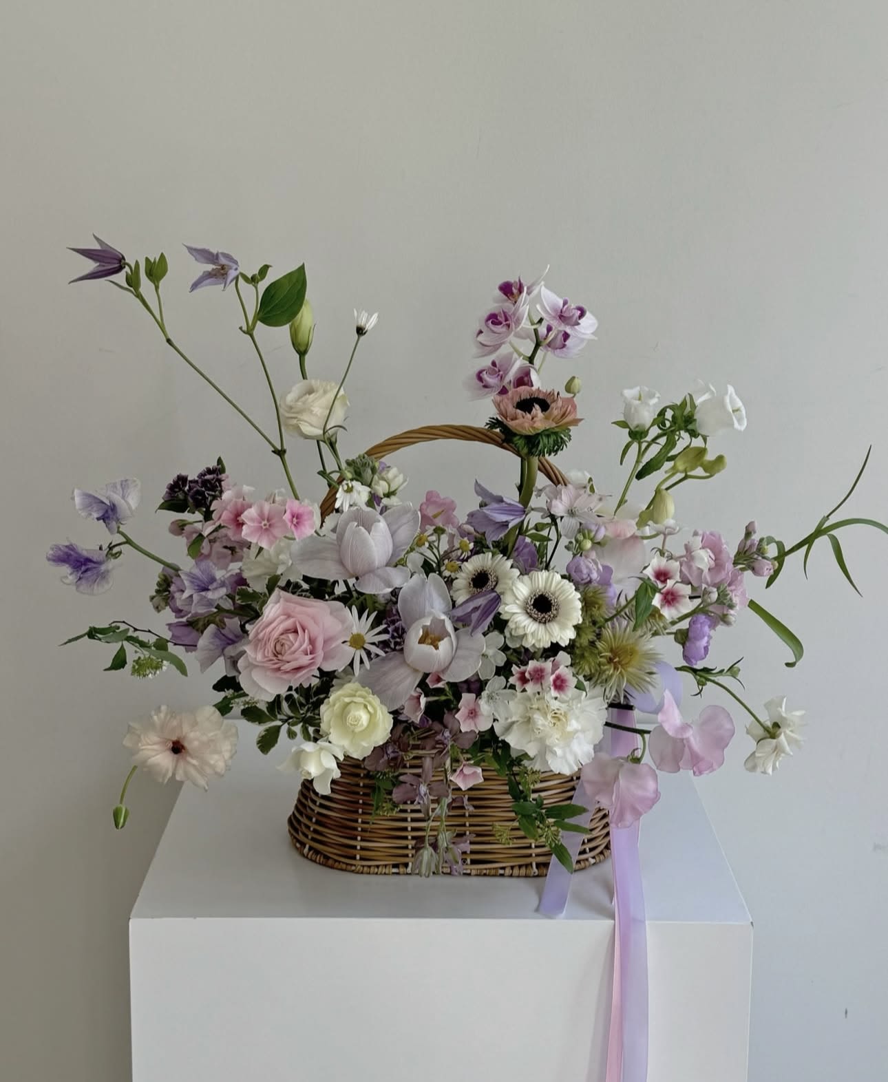 Petal Theory Petal Theory - Delicate, dreamy, and effortlessly romantic — Petal Theory is a floral daydream spun in shades of purple, pink, white, and blush. This basket overflows with soft textures and graceful blooms, each petal placed with care to tell a story of femininity and quiet beauty. Perfect for bridal showers, birthdays, or simply to bring a little fairytale into the everyday, Petal Theory feels like a bouquet picked from a garden in a storybook. Wrapped in whimsy and elegance, it’s made for the hearts that love softly and fully