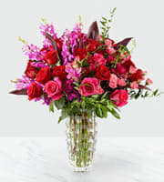 Hot & Lavish Hot & Lavish - Hot colors of romance with rose orchids and more in a beautiful crystal vase