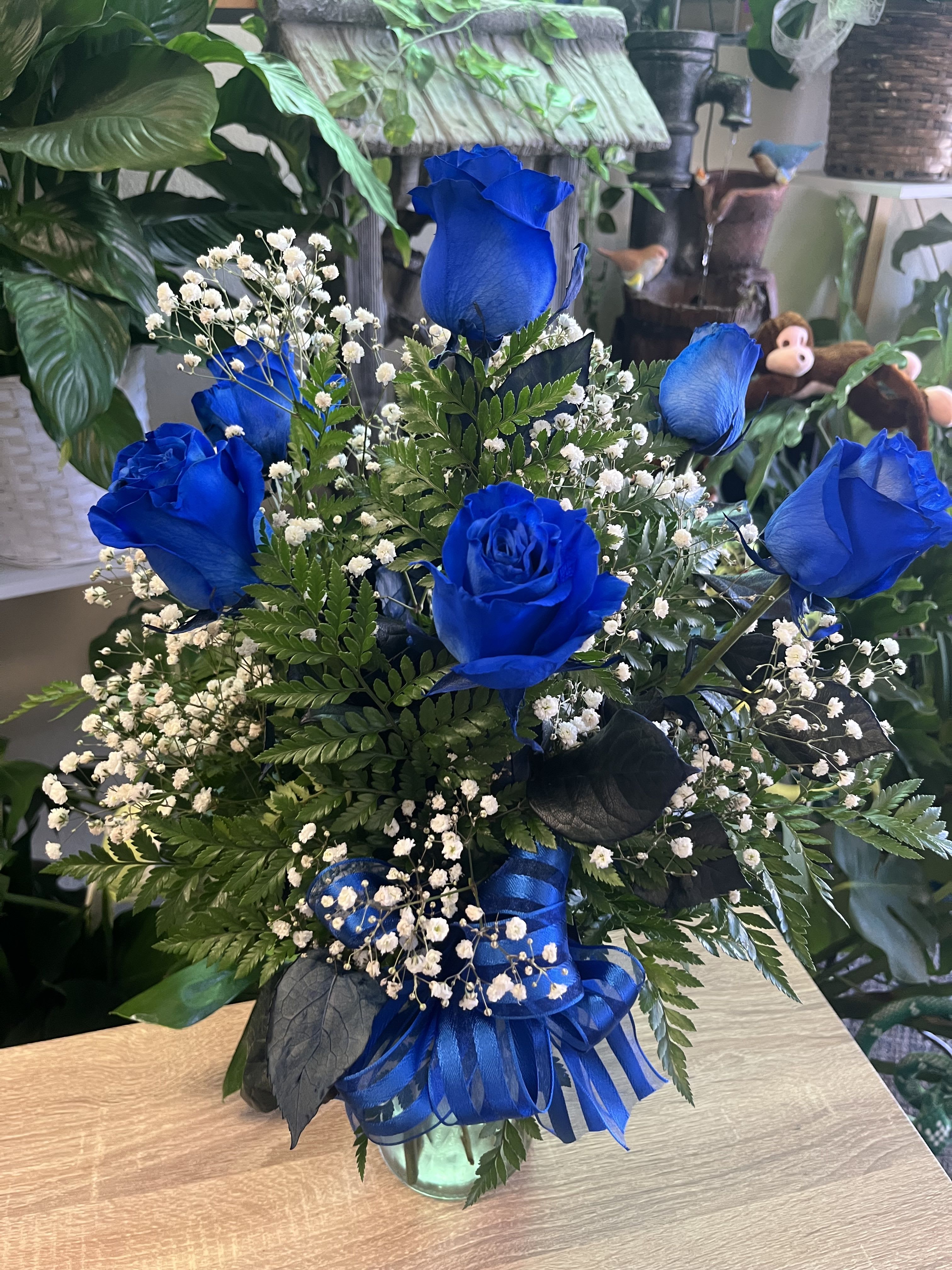 Blue Roses  - half dozen of Royal blue roses with baby’s breath and leather 