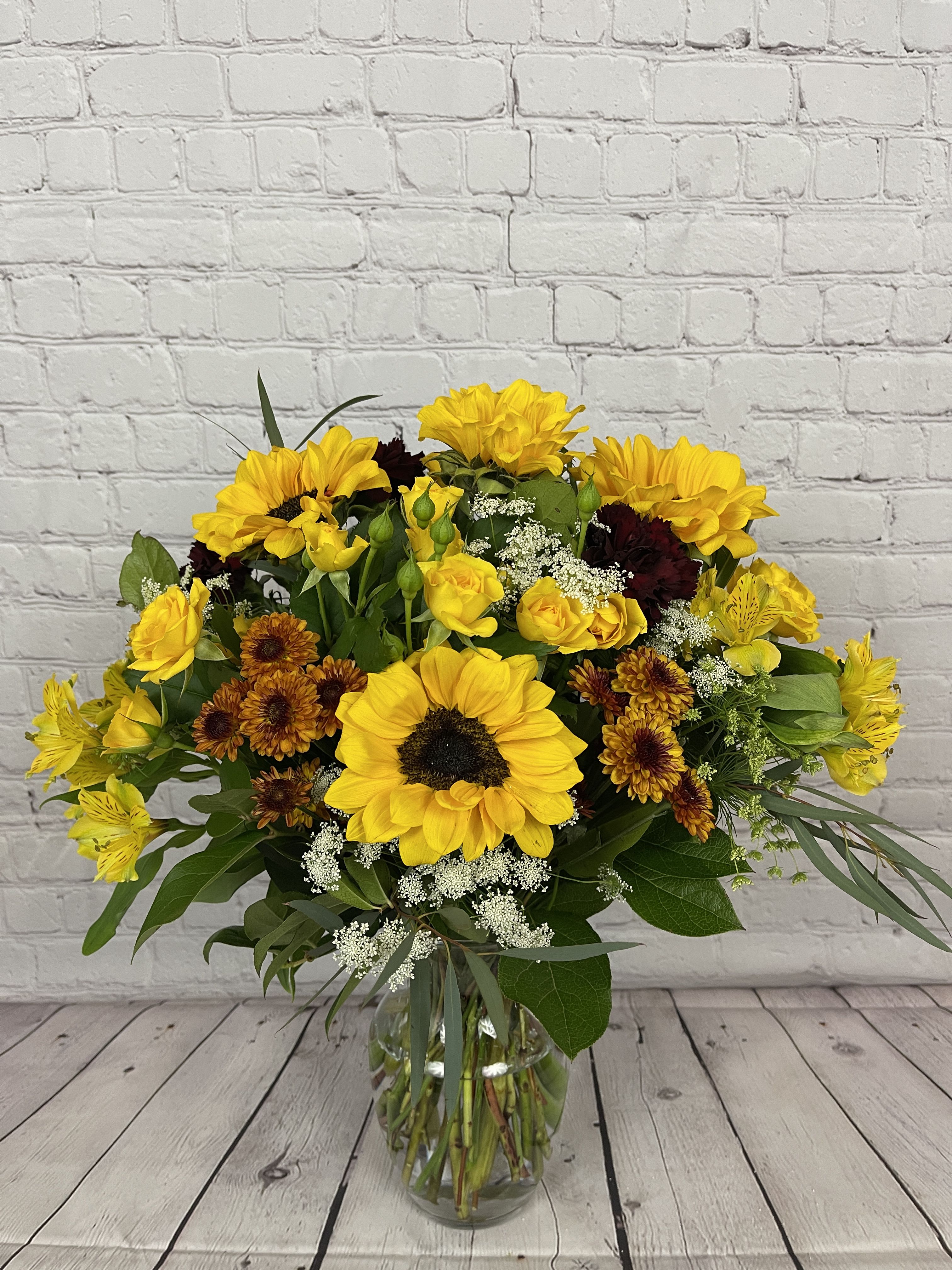 Fall Glow with Spray Roses by Blooming Canyon - Happy Sunflowers and blooming mini spray roses arranged together for a perfect glow to inspire your day.