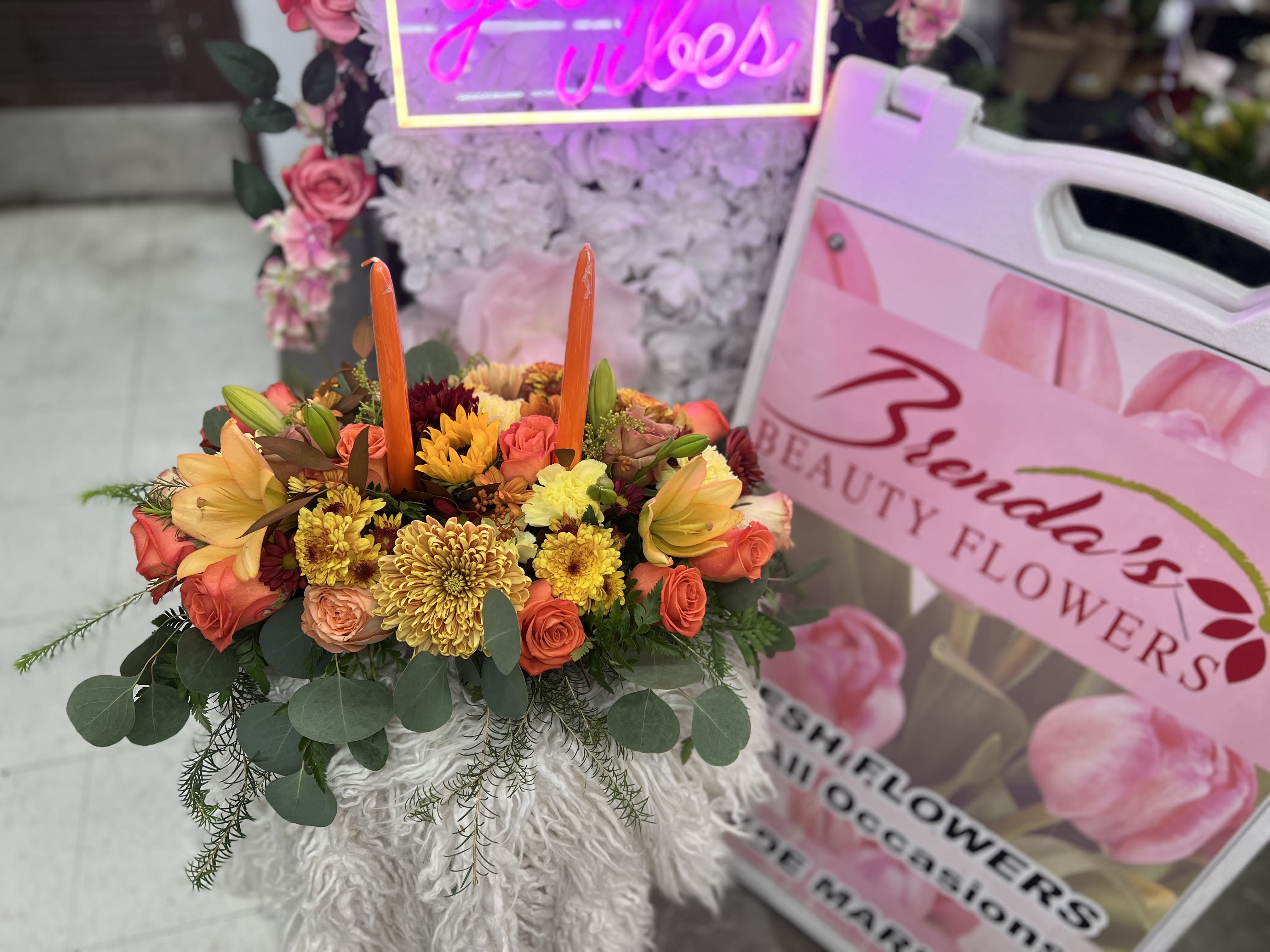 2 candle centerpiece 2 candle centerpiece - Please Note: The bouquet pictured reflects our original design for this product. While we always try to follow the color palette, we may replace stems to deliver the freshest bouquet possible, and we may sometimes need to use a different vase.