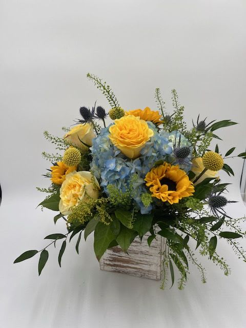 Fall Harvest Fall Harvest - Blue Hydrangea, Yellow Roses, Sunflowers, Craspedia, Thistle and Mixed Greens