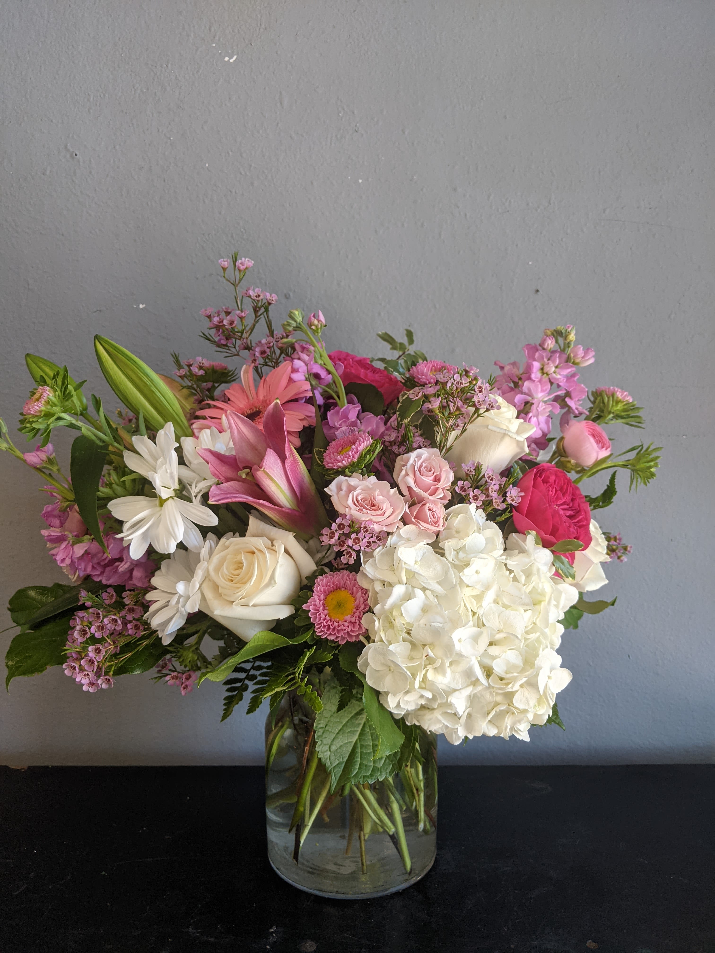 # 140 Summer Floral Arrangement - A beautiful one-of-a-kind arrangement made with fresh seasonal flowers.